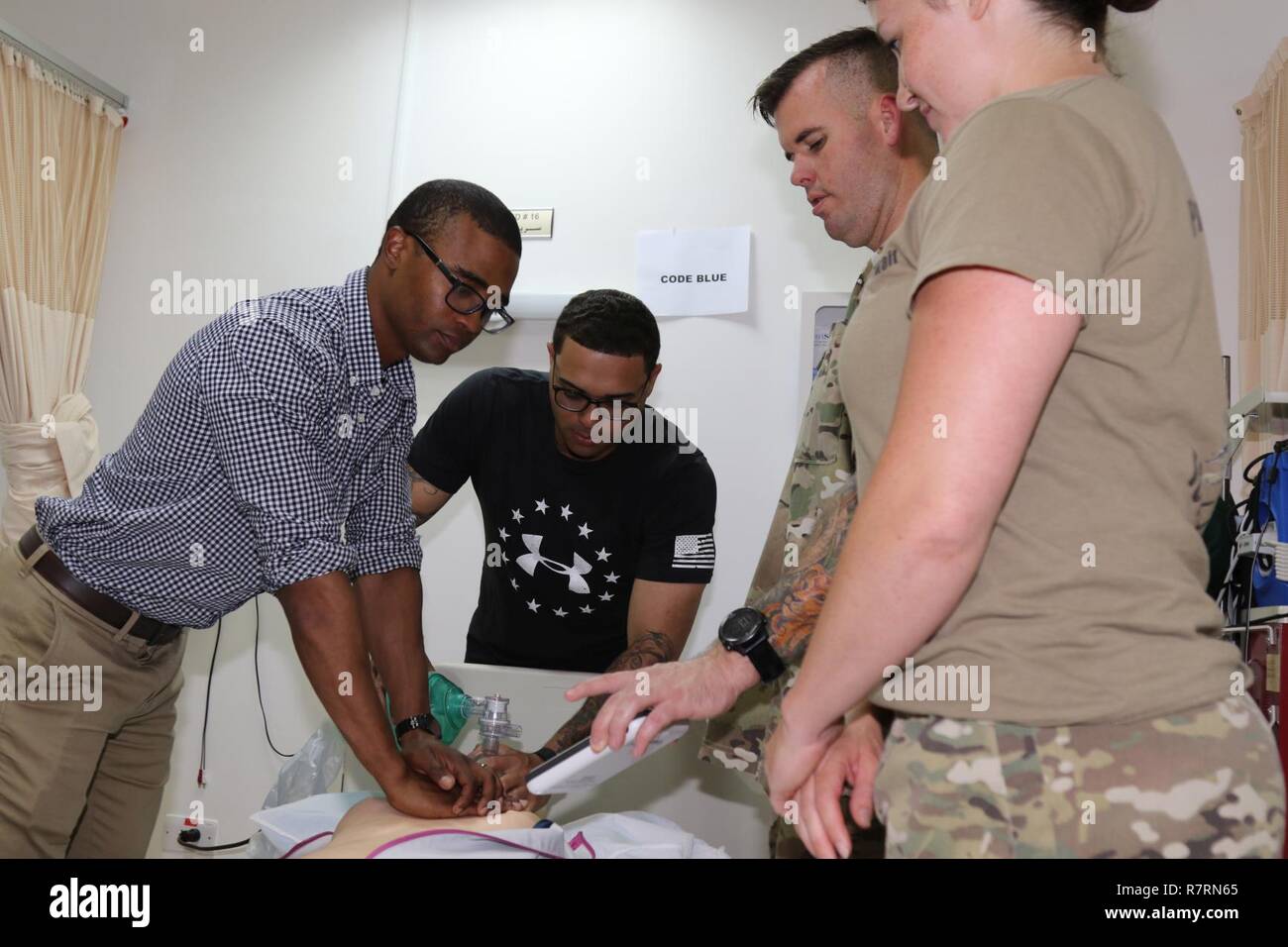 U.S. Army 1st Lt. David Johnson (left) is assisted by Soldiers from the 215th Brigade Support Battalion, while practicing code blue techniques using an Resusci Anne QCPR and an Ambu bag (manual respiratory ventilation), April 1, at Camp Arifjan, Kuwait. The medical refresher training, conducted by the 31st Combat Support Hospital, was for U.S. Army Central area of operation’s nurses and medics, who do not always get chances to work with trauma assessments. Stock Photo