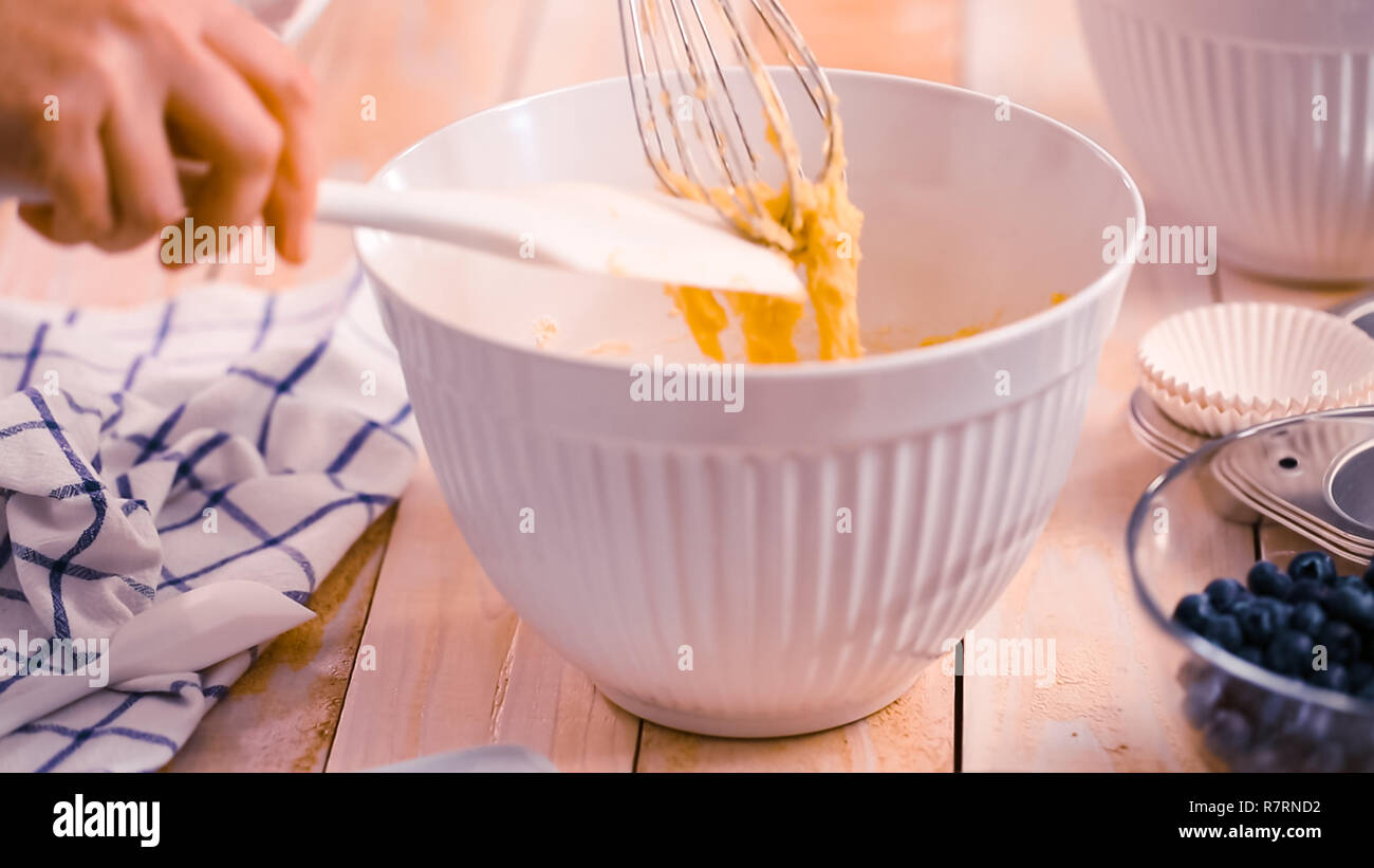 Mixing ingredients together in mixing bowl for blueberry muffins Stock