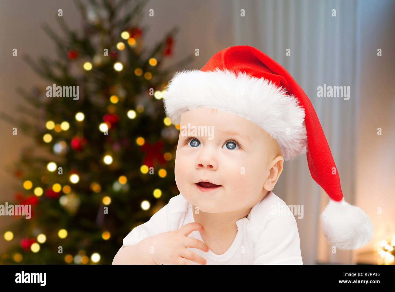 close up of little baby in santa hat at christmas Stock Photo