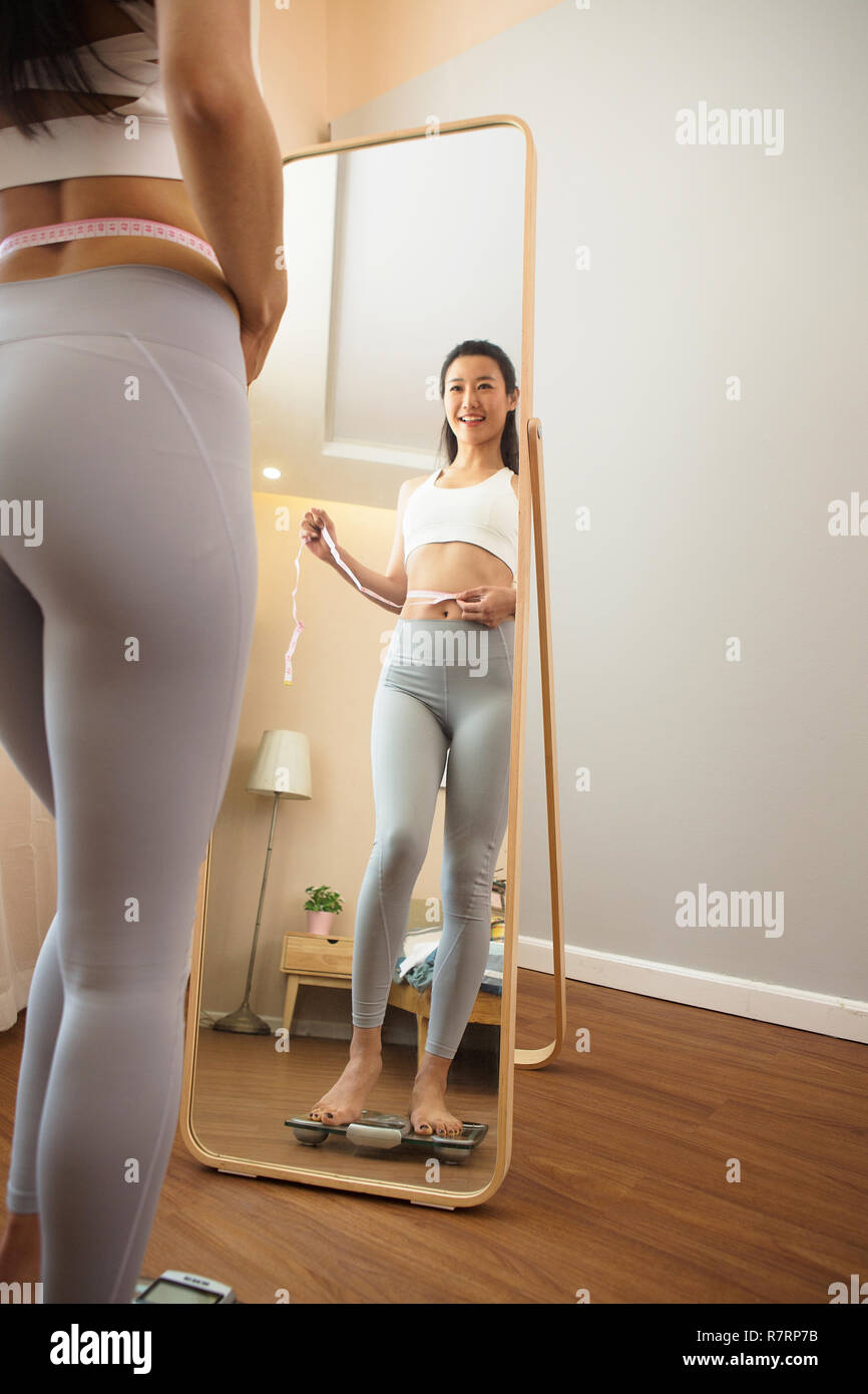 Young woman weight measurement Stock Photo