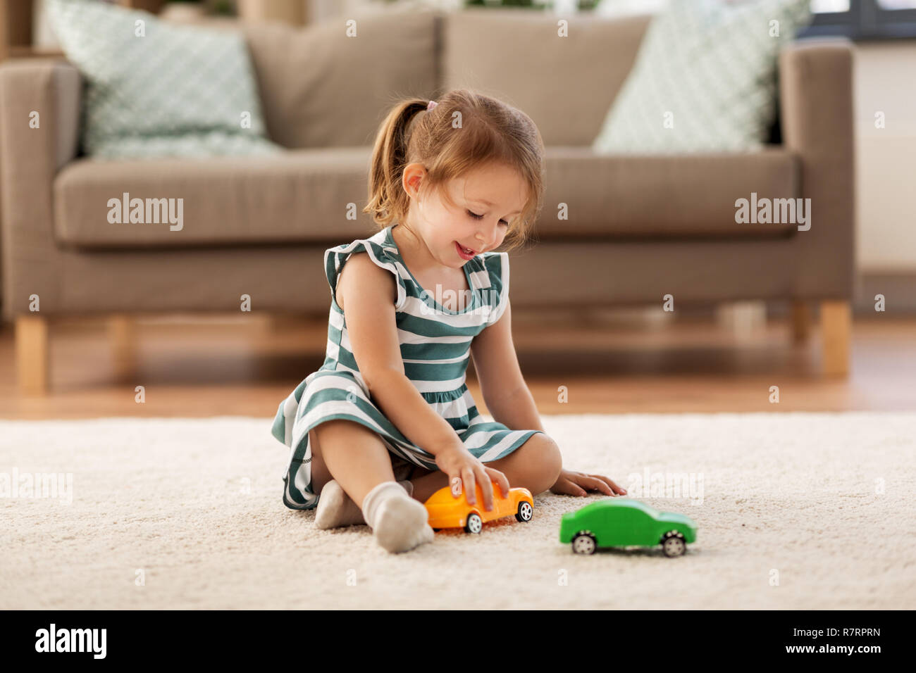 happy baby girl playing with toy car at home Stock Photo - Alamy