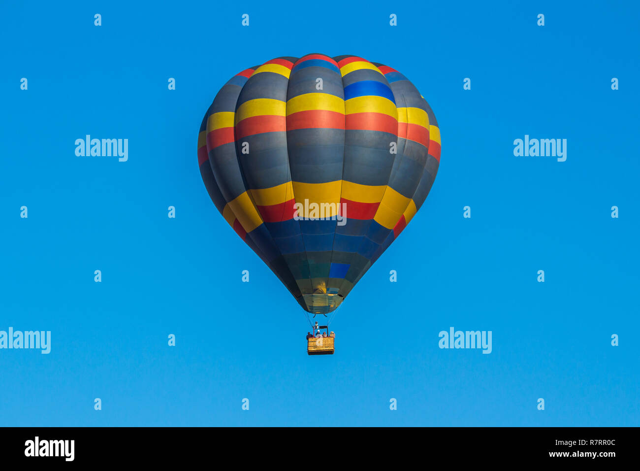 Colorful hot air balloon on a blue sky background Stock Photo - Alamy