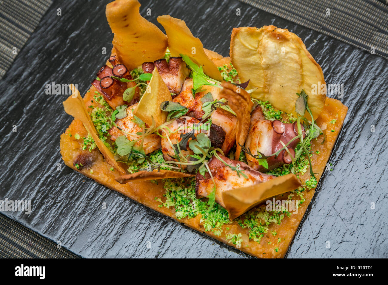 Barbecued octopus with baked potato, vegetables and parsnip. Lotelito rooms and bar. Valencia. Comunidad Valenciana. Spain Stock Photo