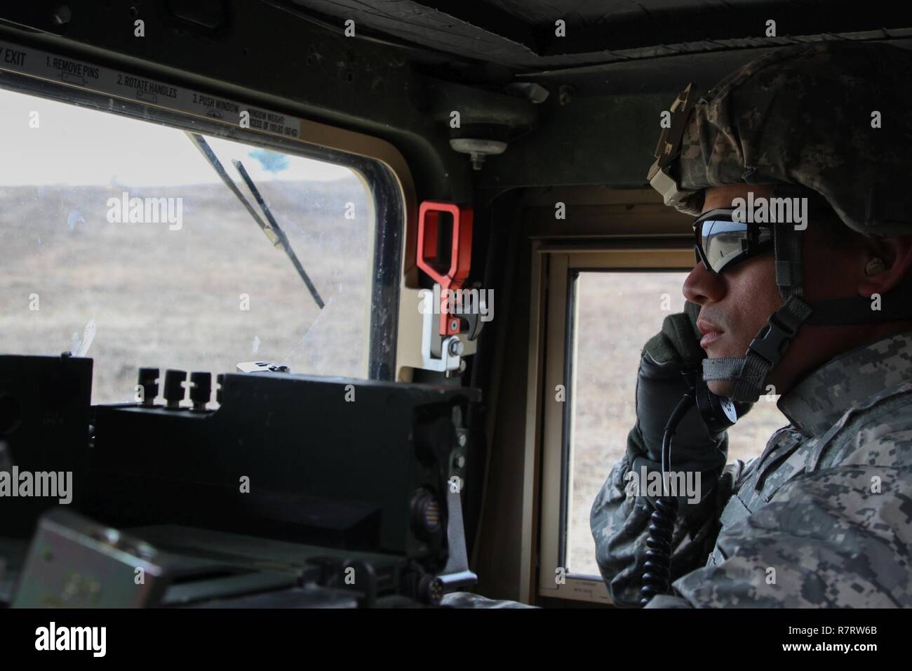 US Army 1st Lt. Edward Manibusan, a human resources officer with the 364th Civil Affairs Brigade, 351st Civil Affairs Command, communicates with the range tower during a firing exercise as part of Operation Cold Steel at Fort McCoy, Wis., on April 02, 2017. The 351st CACOM is responsible for strategic operations through tactical civil affairs support across the U.S. Pacific Command area of responsibility. Operation Cold Steel is the U.S. Army Reserve’s crew-served weapons qualification and validation exercise to ensure that America’s Army Reserve units and Soldiers are trained and ready to dep Stock Photo