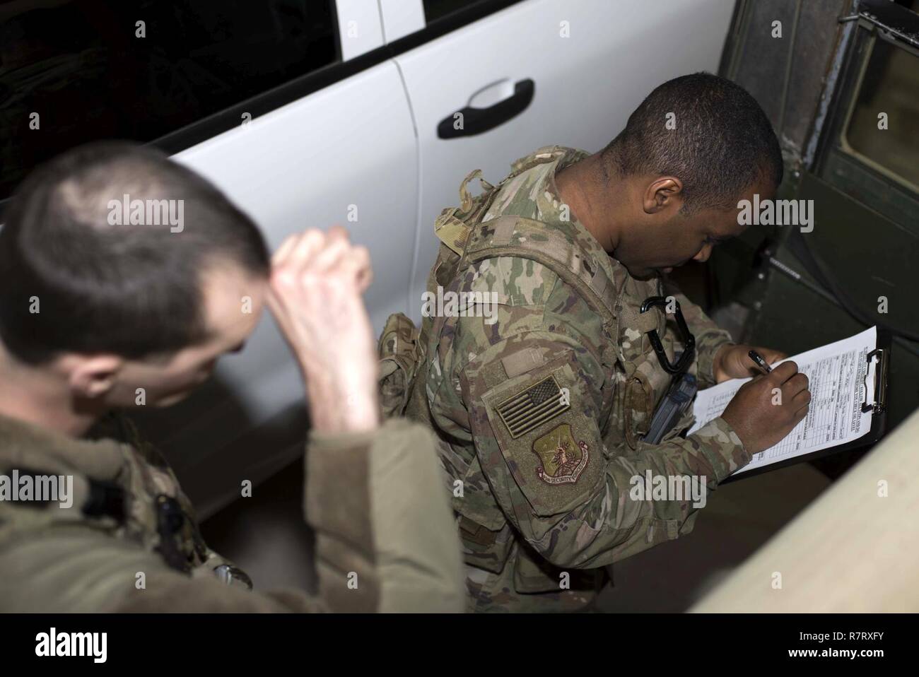 Senior Airman Michael Ripple, 791st Missile Security Forces Squadron response force leader and Staff Sgt. Calvin Smith, 91st Missile Security Force Squadron flight security controller, review a pre-mission vehicle checklist at Minot Air Force Base, N.D., Mar. 28, 2017. Vehicle checks help prevent breakdowns and identify other potential problems. Stock Photo