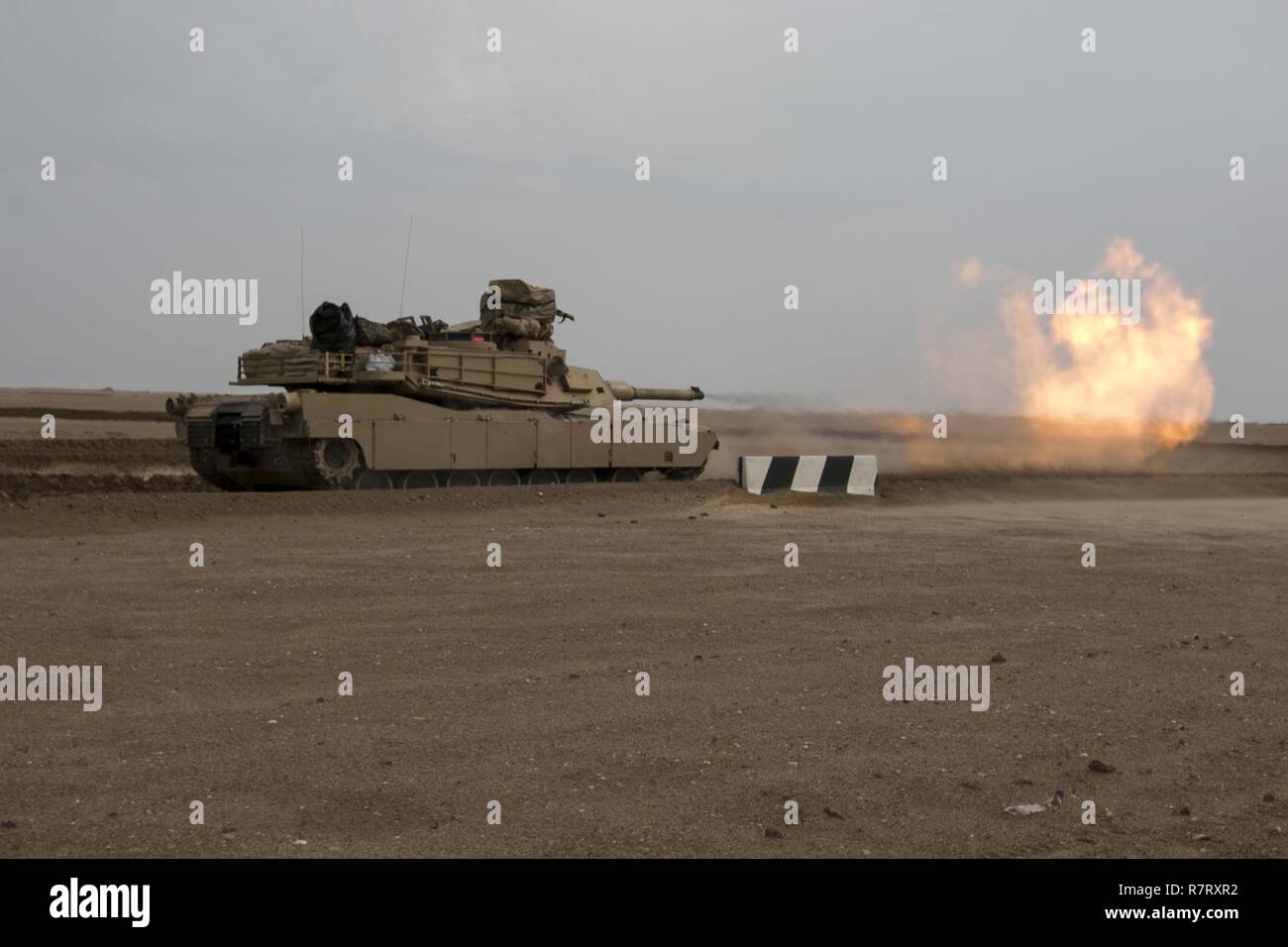 A 3rd Armored Brigade Combat Team, 1st Cavalry Division M1A2 Abrams Main Battle Tank engages targets during the brigade's Table VI qualifications at the Udairi Range Complex March 28. The brigade tank and Bradley crews spent about two weeks in the field conducting sustainment gunnery to ensure all the crews qualified at day and night fire to maintain proficiency. Stock Photo