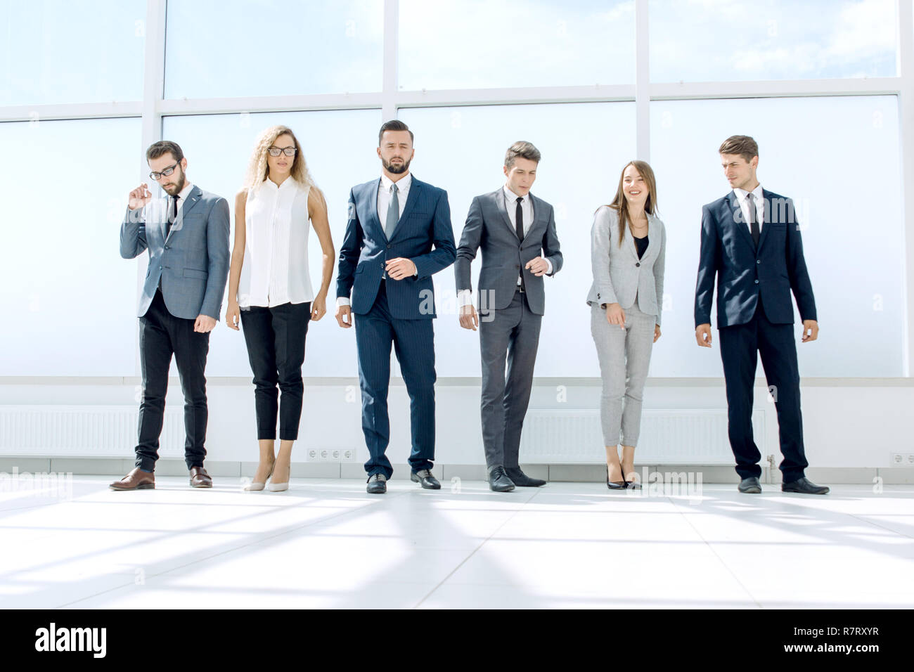successful business team standing in the office hall Stock Photo - Alamy