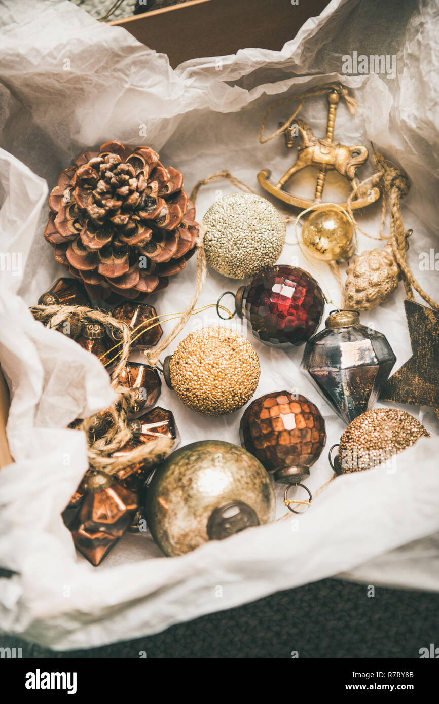 Christmas tree decoration toys and cones in box, vertical composition Stock Photo