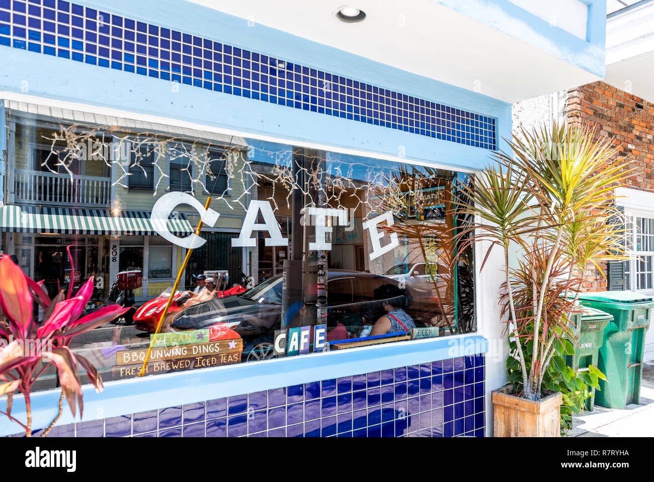 Key West, USA - May 1, 2018: The Cafe sign on window store healthy restaurant shop serving vegetarian vegan food in Florida city travel, sunny day, st Stock Photo