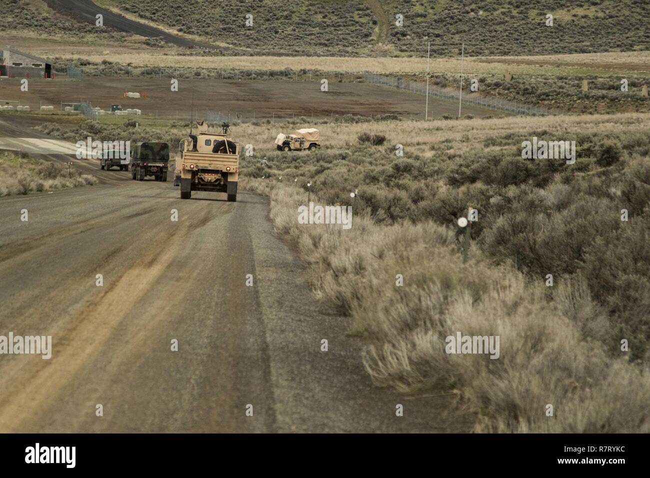 Soldiers from 308th Brigade Support Battalion, 17th Field Artillery Brigade move up to the disabled vehicle they believe is their objective to recover as part of their training evaluation at Yakima Training Center, Wash., April 8, 2017. 308th BSB is at YTC to conduct evaluations on how well the soldiers are being trained on their combat operation tasks. Stock Photo