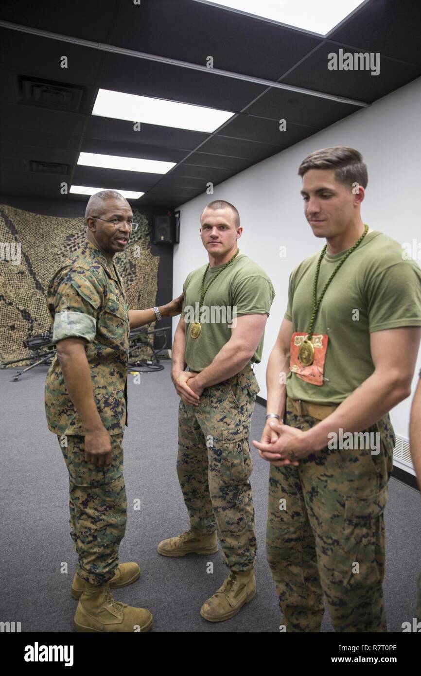 U.S. Marine Corps Lt. Gen. Ronald L. Bailey, deputy commandant, Plans, Policies, and Operations, presents medals to the first place finishing team of the Montford Point Biathlon at Camp Barrett, Marine Corps Base Quantico, Va., April 7, 2017. During World War II, President Roosevelt awarded African Americans the opportunity to be recruited into the Marine Corps, and provided basic training at Montford Point Camp in North Carolina. This annual event is held for TBS Marines, to honor the hardships faced by Montford Point Marines by competing in a 6.5 mile course, in which four-man teams run from Stock Photo