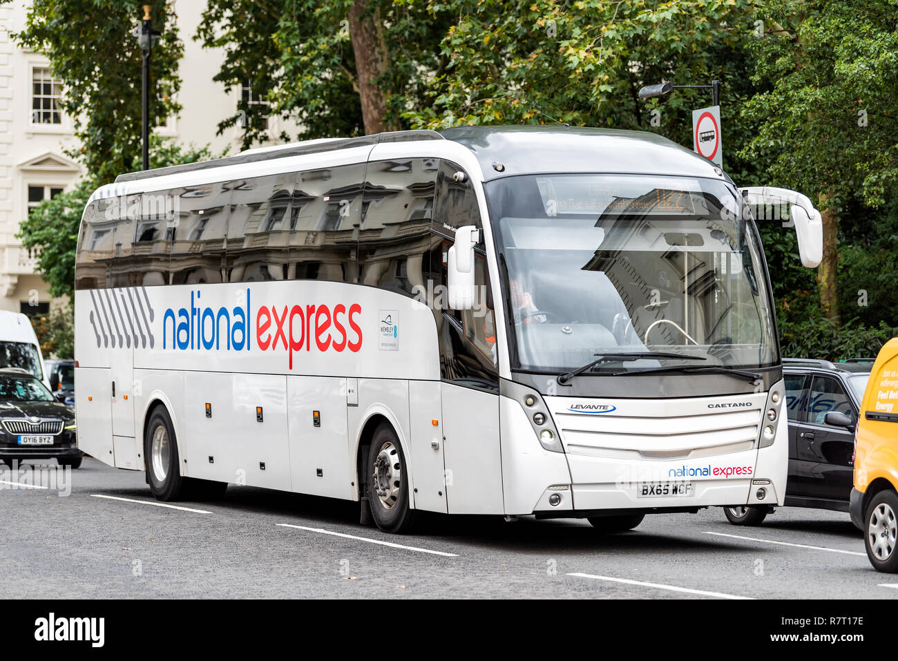 London, United Kingdom - September 12, 2018: National Express coach shuttle bus white sign text modern luxury transport service in traffic on street r Stock Photo