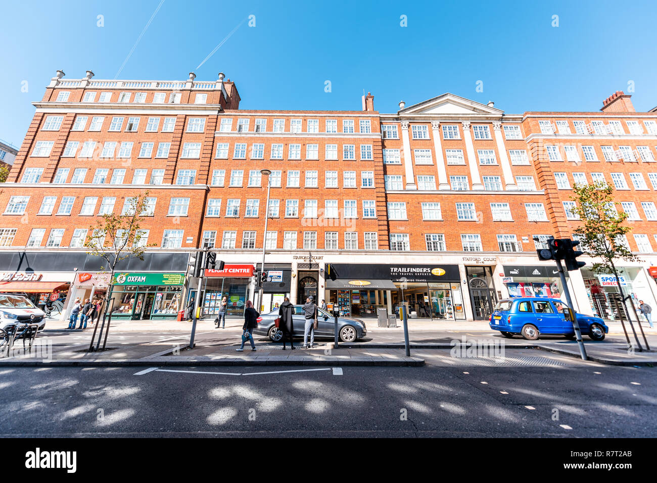 London, UK - September 13, 2018: Neighborhood district of Kensington, High street, brick architecture, road traffic, shopping stores Stock Photo