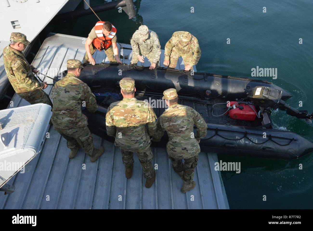 Members of U.S. Army 74th Dive Detachment, from Fort Eustis, Virginia, lower thier dive boat into the water prior to dive operations during Operation Pacific Reach Exercise 2017 in Pohang, Republic of Korea, April 7, 2017. OPRex17 is a bilateral training event designed to ensure readiness and sustain the capabilities which strengthen ROK-U.S. Alliance. Coast Guardsmen will serve as part of combined task group conducting ports, waterways and coastal security operations protecting U.S.-ROK assets and personnel exercising an Area Distribution Center (ADC), an Air Terminal Supply Point (ATSP), Log Stock Photo