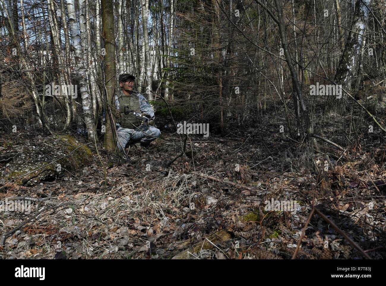 Staff Sgt. Jesse Sengsouk, 435th Security Forces Squadron’s Ground Combat Readiness Training Center instructor, shows students of the Security Operations Course a hidden improvised explosion device during the IED detection portion of the course on Ramstein Air Base, Germany, March 25, 2017. During the IED detection portion, the students marched through a wooded area and had to detect devices hidden along the way. Airmen assigned to the 86th SFS, 422nd SFS, 100th SFS, and 569th U.S. Forces Police Squadron participated in the course. Stock Photo