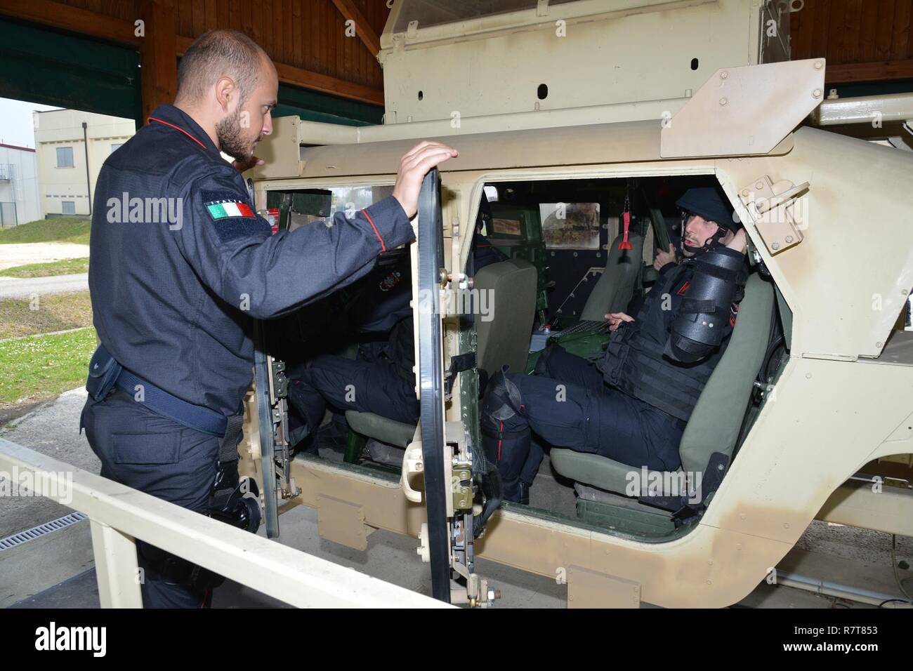 Italian Carabinieri of the 7th Regiment Carabinieri “Laives” Bolzano and 13th Regiment Carabinieri “Friuli Venezia Giulia” Gorizia conduct training using the High Mobility Multipurpose Wheeled Vehicle (HMMWV) egress assistance trainer (HEAT), at Caserma Ederle Vicenza, Italy, April 6, 2017. The simulator allows soldiers to practice exit from vehicles, skills and engage in realistic scenarios. Carabinieri use U.S. Army RTSD South equipment to enhance the bilateral relations and to expand levels of cooperation and the capacity of the personnel involved in joint operations. Stock Photo