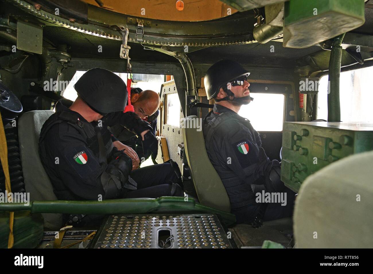 Italian Carabinieri of the 7th Regiment Carabinieri “Laives” Bolzano and 13th Regiment Carabinieri “Friuli Venezia Giulia” Gorizia conduct training using the High Mobility Multipurpose Wheeled Vehicle (HMMWV) egress assistance trainer (HEAT), at Caserma Ederle Vicenza, Italy, April 6, 2017. The simulator allows soldiers to practice exit from vehicles, skills and engage in realistic scenarios. Carabinieri use U.S. Army RTSD South equipment to enhance the bilateral relations and to expand levels of cooperation and the capacity of the personnel involved in joint operations. Stock Photo