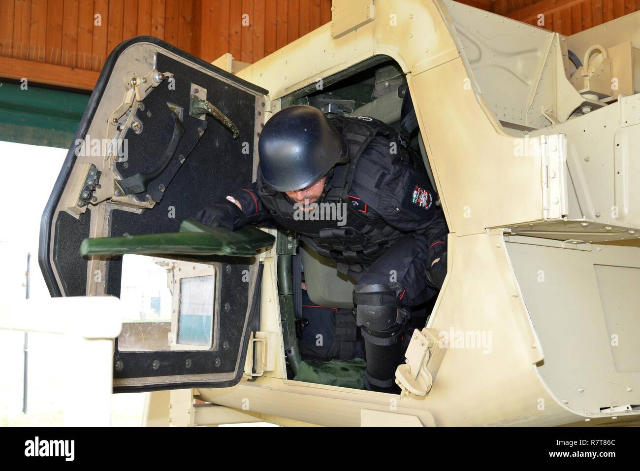 Italian Carabinieri of the 7th Regiment Carabinieri “Laives” Bolzano and 13th Regiment Carabinieri “Friuli Venezia Giulia” Gorizia conduct training using the High Mobility Multipurpose Wheeled Vehicle (HMMWV) egress assistance trainer (HEAT), at Caserma Ederle Vicenza, Italy, April 6, 2017. The simulator allows soldiers to practice exit from vehicles, skills and engage in realistic scenarios. Carabinieri use U.S. Army RTSD South equipment to enhance the bilateral relations and to expand levels of cooperation and the capacity of the personnel involved in joint operations. Stock Photo