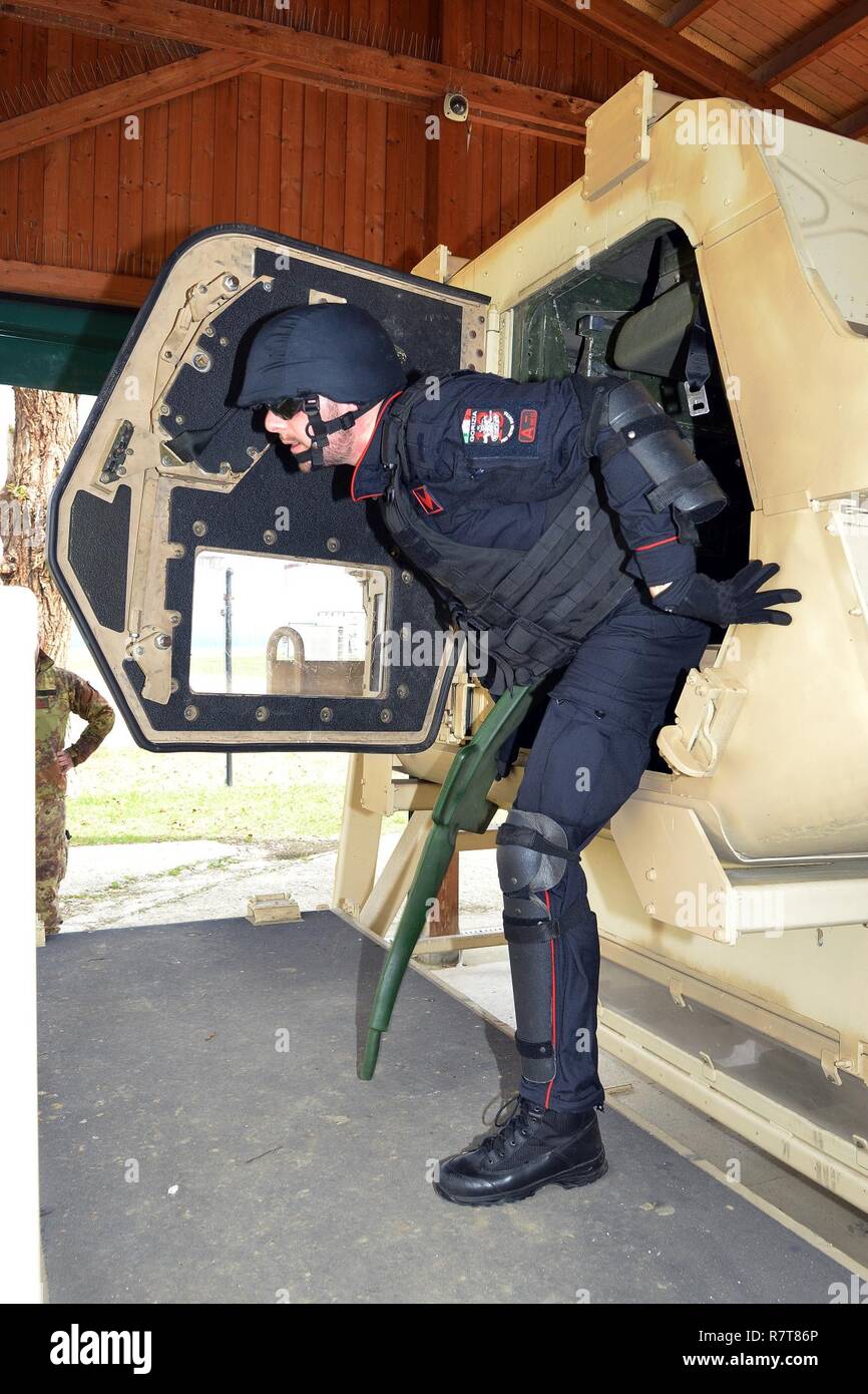 Italian Carabinieri of the 7th Regiment Carabinieri “Laives” Bolzano and 13th Regiment Carabinieri “Friuli Venezia Giulia” Gorizia conduct training using the High Mobility Multipurpose Wheeled Vehicle (HMMWV) egress assistance trainer (HEAT), at Caserma Ederle Vicenza, Italy, April 6, 2017. The simulator allows soldiers to practice exit from vehicles, skills and engage in realistic scenarios. Carabinieri use U.S. Army RTSD South equipment to enhance the bilateral relations and to expand levels of cooperation and the capacity of the personnel involved in joint operations. Stock Photo