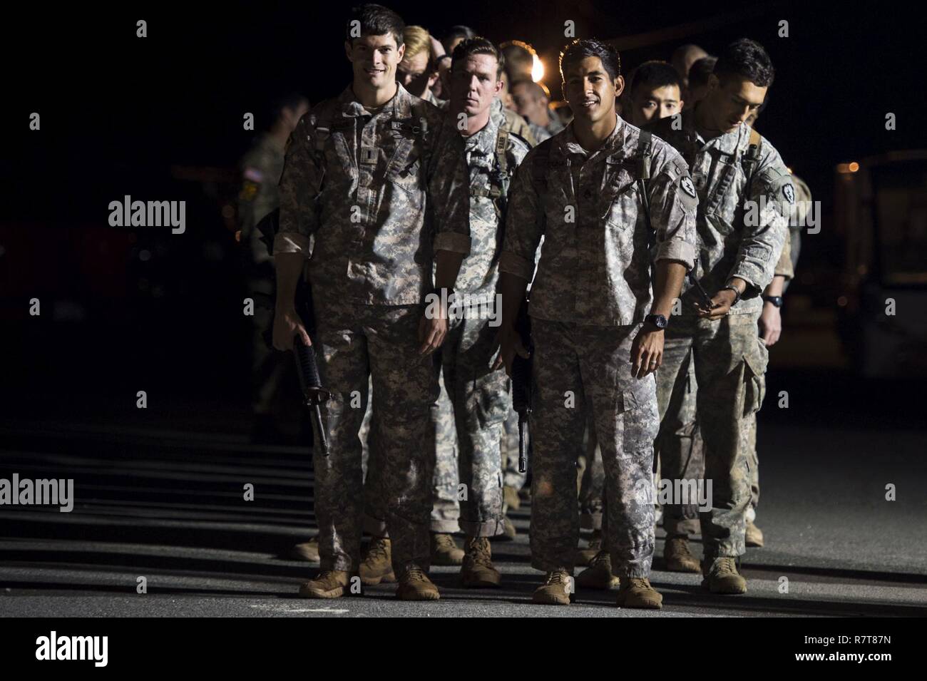 U.S. Army rangers wait for their team to be called in the opening ceremony during the Best Ranger Competition 2017 at Fort Benning, Ga., April 7, 2017. The 34th annual David E. Grange Jr. Best Ranger Competition 2017 is a three-day event consisting of challenges to test competitor's physical, mental, and technical capabilities. Stock Photo