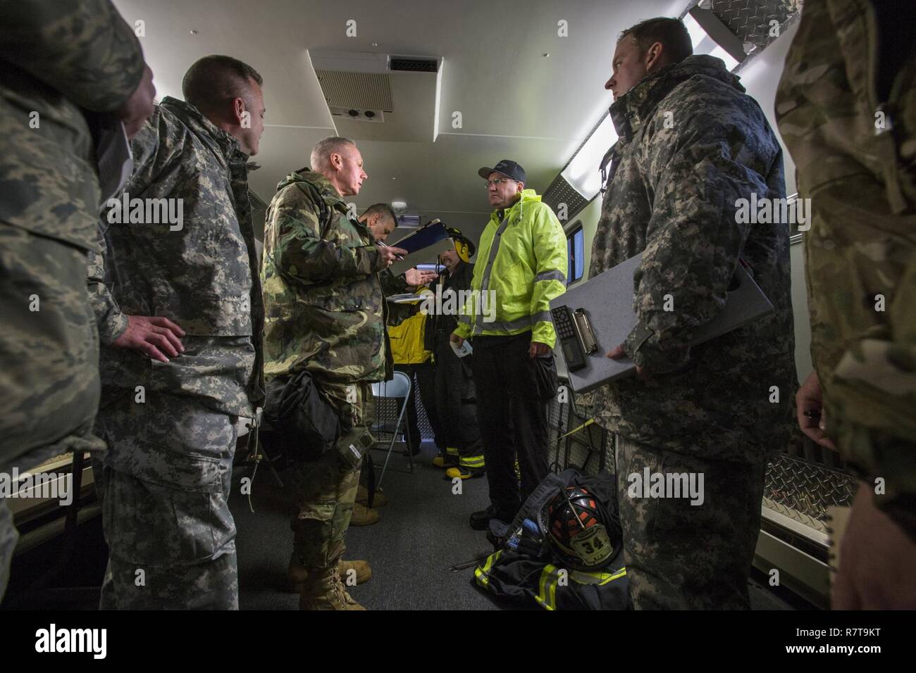Lt. Col. George Christenson, third from left, commander of the New Jersey National Guard's 21st Weapons of Mass Destruction-Civil Support Team, is briefed by members of the Monmouth County Hazmat team during a joint training exercise at Fort Monmouth, N.J., April 6, 2017. The 21st WMD-CST is a joint unit comprised of New Jersey National Guard Soldiers and Airmen whose mission is to support civil authorities by identifying chemical, biological, radiological, and nuclear substances in either man-made or natural disasters. (New Jersey National Guard Stock Photo