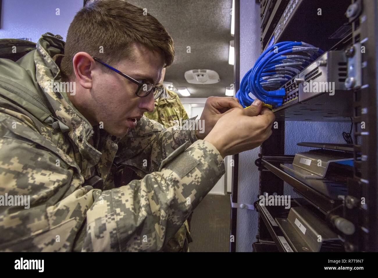 Staff Sgt. Chris M. Maute with the New Jersey National Guard's 21st Weapons of Mass Destruction-Civil Support Team, connects server cables during a joint training exercise with members of the Monmouth County Hazmat team at Fort Monmouth, N.J., April 6, 2017. The 21st WMD-CST is a joint unit comprised of New Jersey National Guard Soldiers and Airmen whose mission is to support civil authorities by identifying chemical, biological, radiological, and nuclear substances in either man-made or natural disasters. (New Jersey National Guard Stock Photo