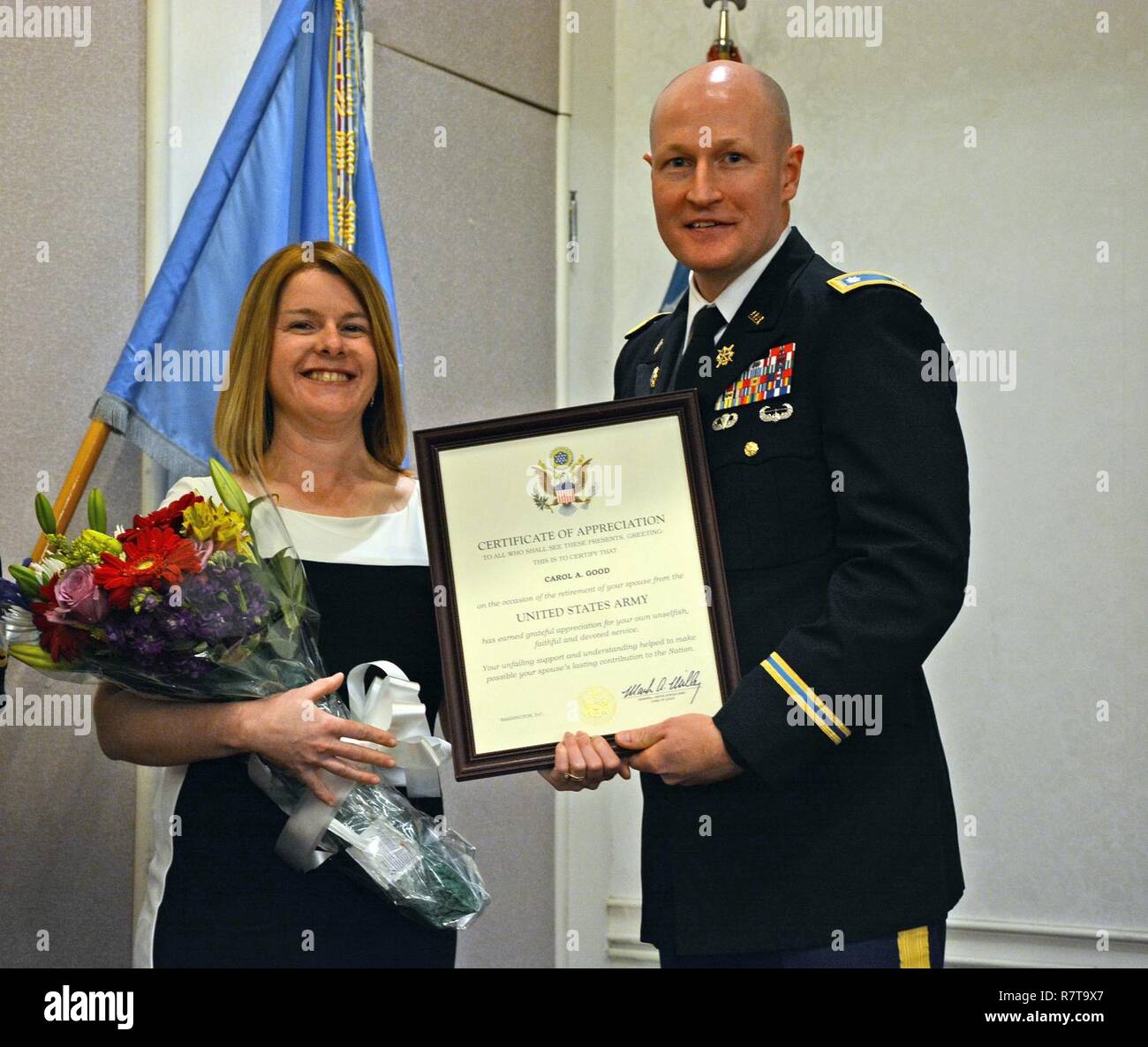 FORT MEADE, Maryland - Carol, the spouse of Master Sgt. Anthony R. Good, the senior enlisted leader for Computer Network Operations, assigned to the 741st Military Intelligence Battalion, receives a Certificate of Appreciation from Lt. Col. Galen R. Kane, commander of the 741st MI Bn., during his retirement ceremony April 5, at Club Meade. Stock Photo