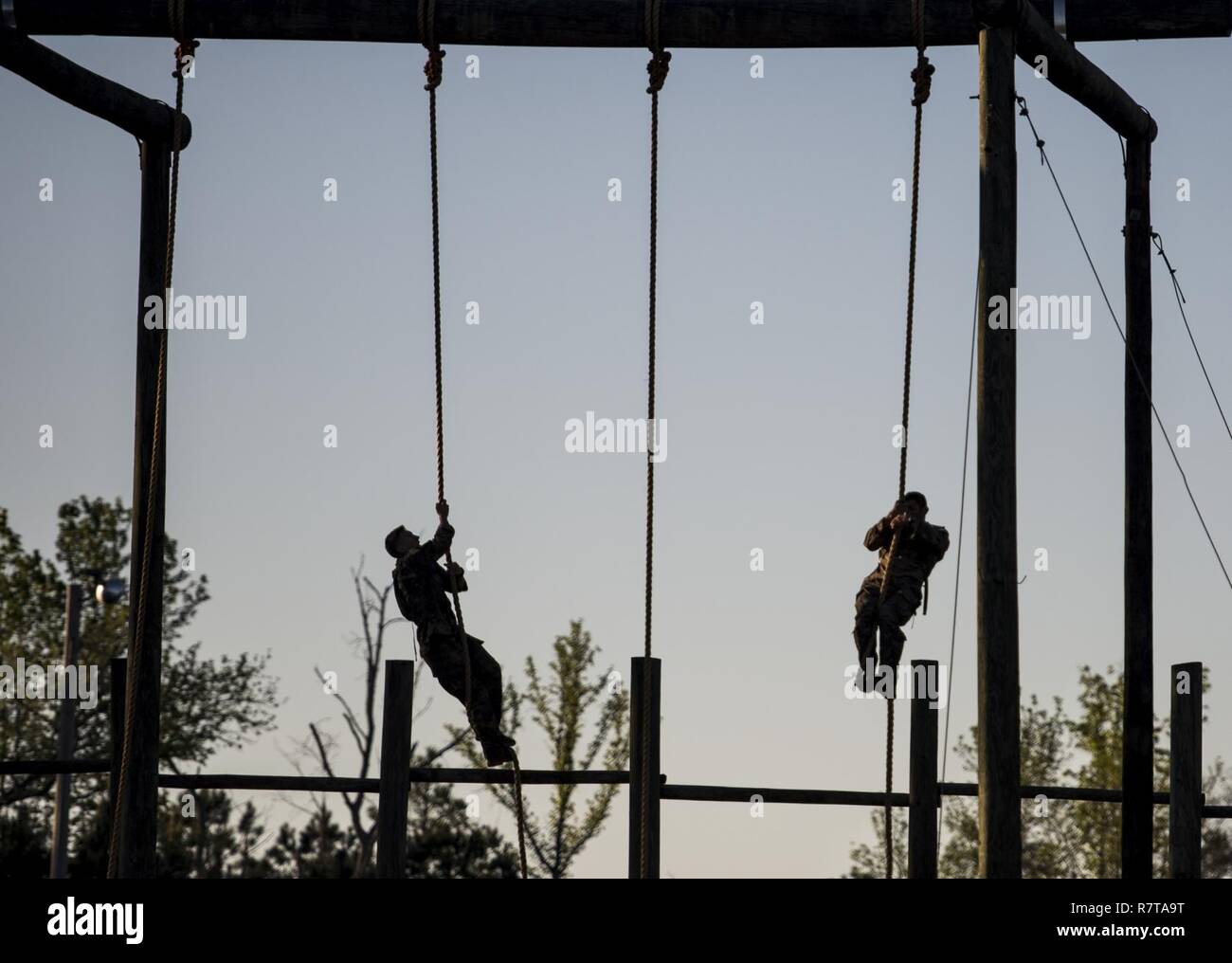 U.S. Army Rangers climb a rope obstacle during the Best Ranger Competition 2017 in Fort Benning, Ga., April 7, 2017. The 34th annual David E. Grange Jr. Best Ranger Competition 2017 is a three-day event consisting of challenges to test competitor's physical, mental, and technical capabilities. Stock Photo