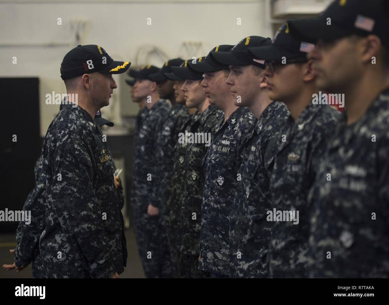 SOUTH CHINA SEA (April 6, 2017) Capt. Mark A. Melson, commanding officer of the amphibious assault ship USS Makin Island (LHD 8), inspects engineering department Sailors in the hangar bay. The ship is the flagship of its amphibious ready group, which is operating in the Indo-Asia-Pacific region to enhance amphibious capability with regional partners and to serve as a ready-response force for any type of contingency. Stock Photo