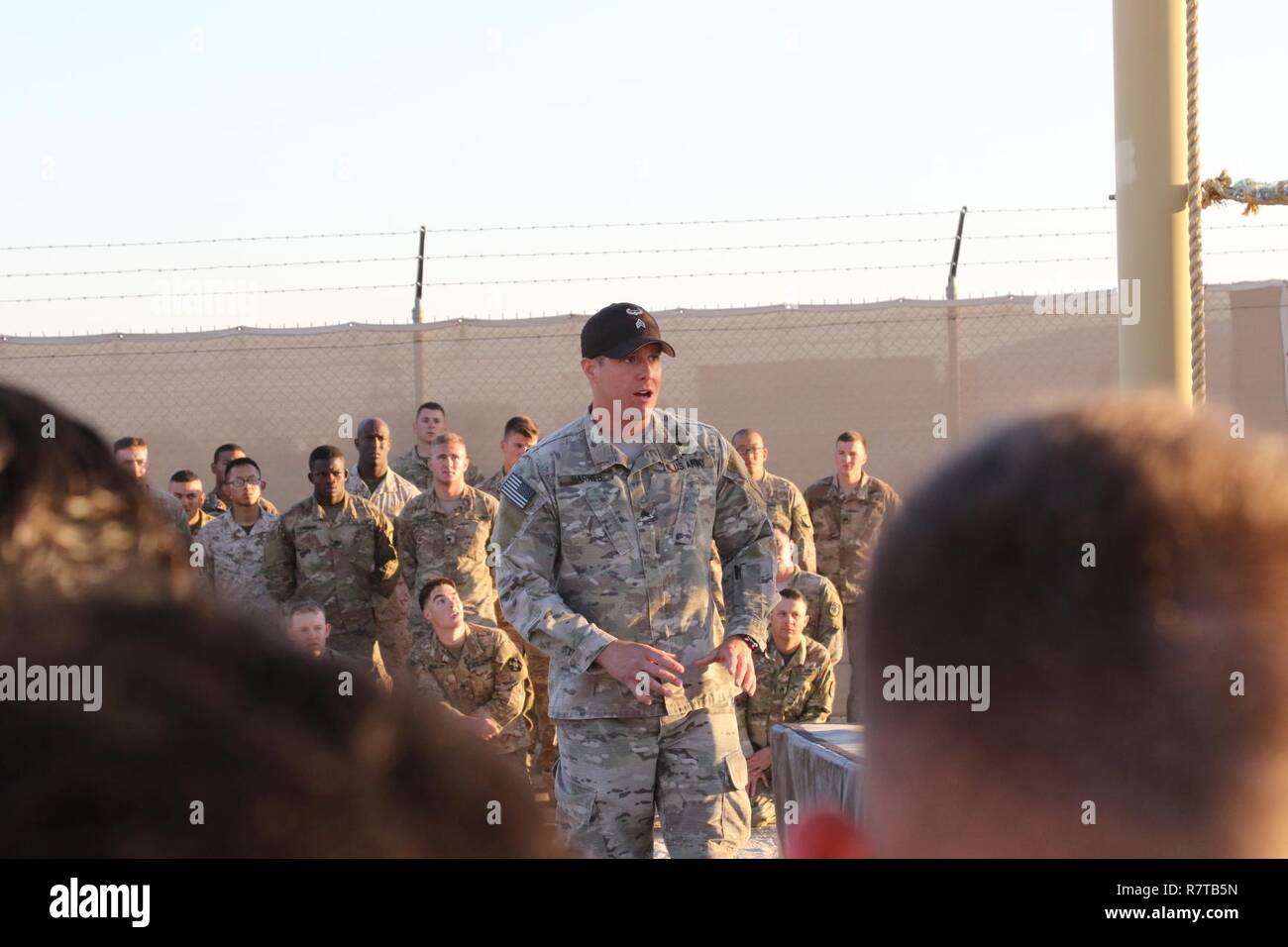 U.S. Army Sgt. Cruser Barnes, cavalry scout and air assault instructor, Army National Guard Warrior Training Center, gives instructions on how to properly navigate the ‘Tough One’ obstacle, during day zero of U.S. Army Central’s first Air Assault Course, April 4, 2017, at Camp Buehring, Kuwait. The ‘Tough One’ obstacle includes rope, net climbing and walking along wooden planks. It is one of two obstacles candidates must pass in order to continue forward on day zero. The Air Assault Course is a 12-day class that allows U.S. military personnel in the USARCENT theater of operations the unique op Stock Photo