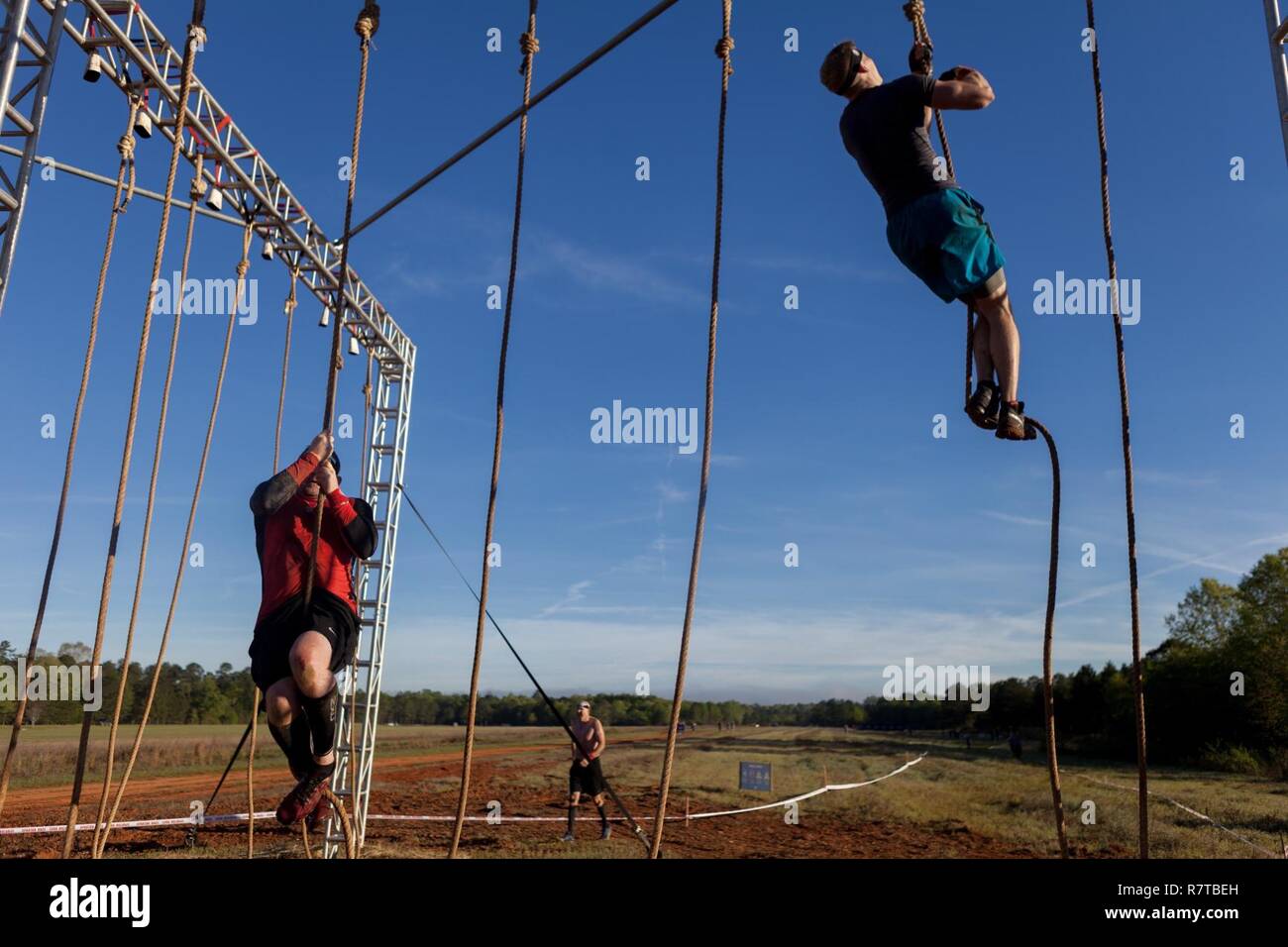 Spartan Race competitors perform a rope climb during a Spartan