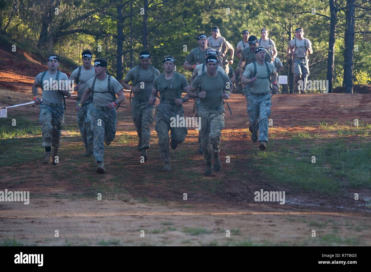 U.S Army Rangers run in a Spartan Race during the Best Ranger Competition 2017 at Fort Mitchell, Ala., April 8, 2017. The 34th annual David E. Grange Jr. Best Ranger Competition 2017 is a three-day event consisting of challenges to test competitor's physical, mental, and technical capabilities. Stock Photo