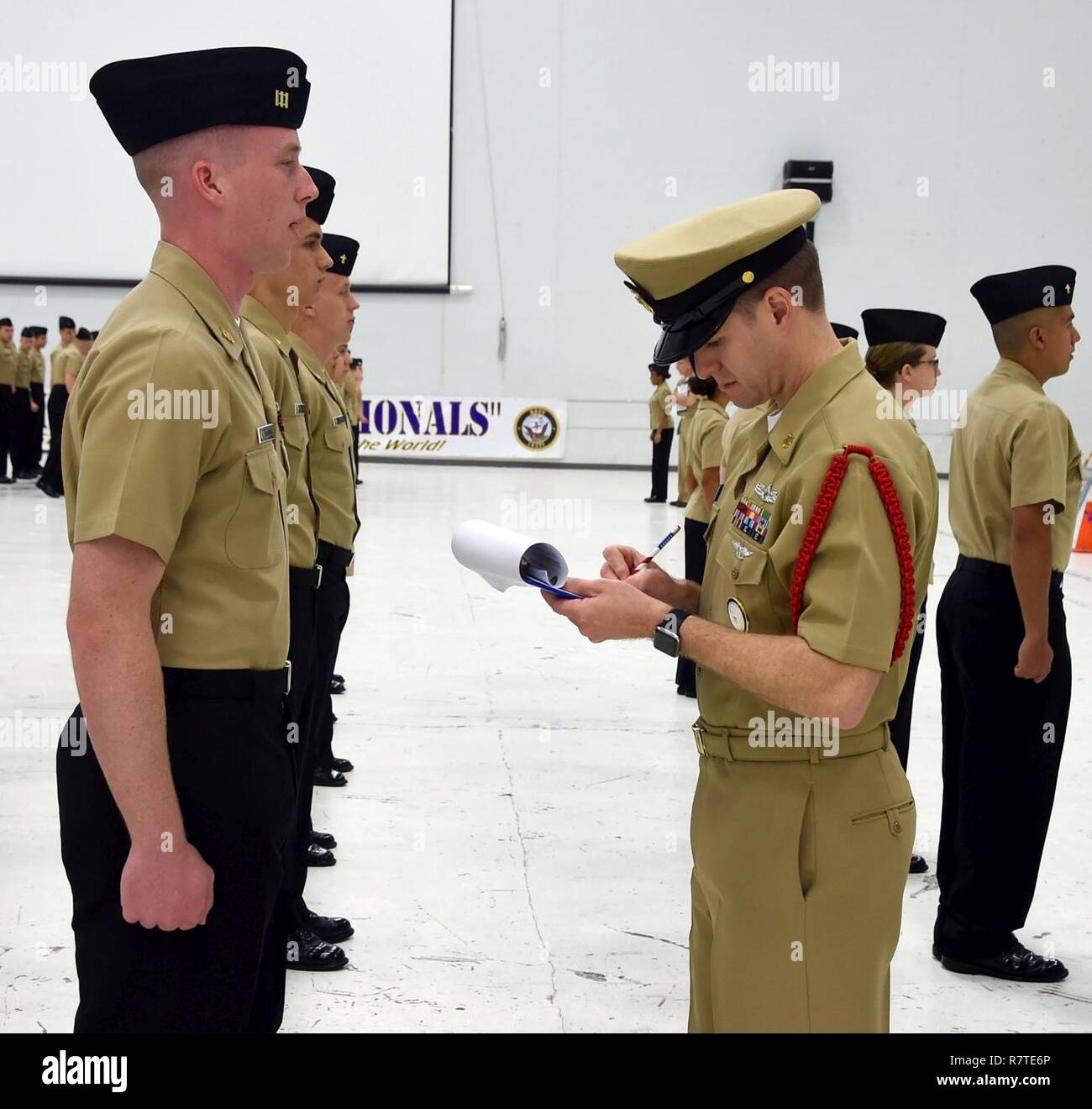 Senior Chief Machinist Mate Jeffrey Guilmet, a Recruit Division Commander (RDC) from Officer Training Command (OTCN), Newport, Rhode Island, performs a personnel inspection on Navy Junior Reserve Officers Training Corps (NJROTC) cadet Boston Clattenbury, a senior from Smithson Valley High School in Spring Branch, Texas, during the 2017 NJROTC National Academic, Athletic and Drill Championship on Naval Air Station Pensacola, Florida, April 7. Stock Photo