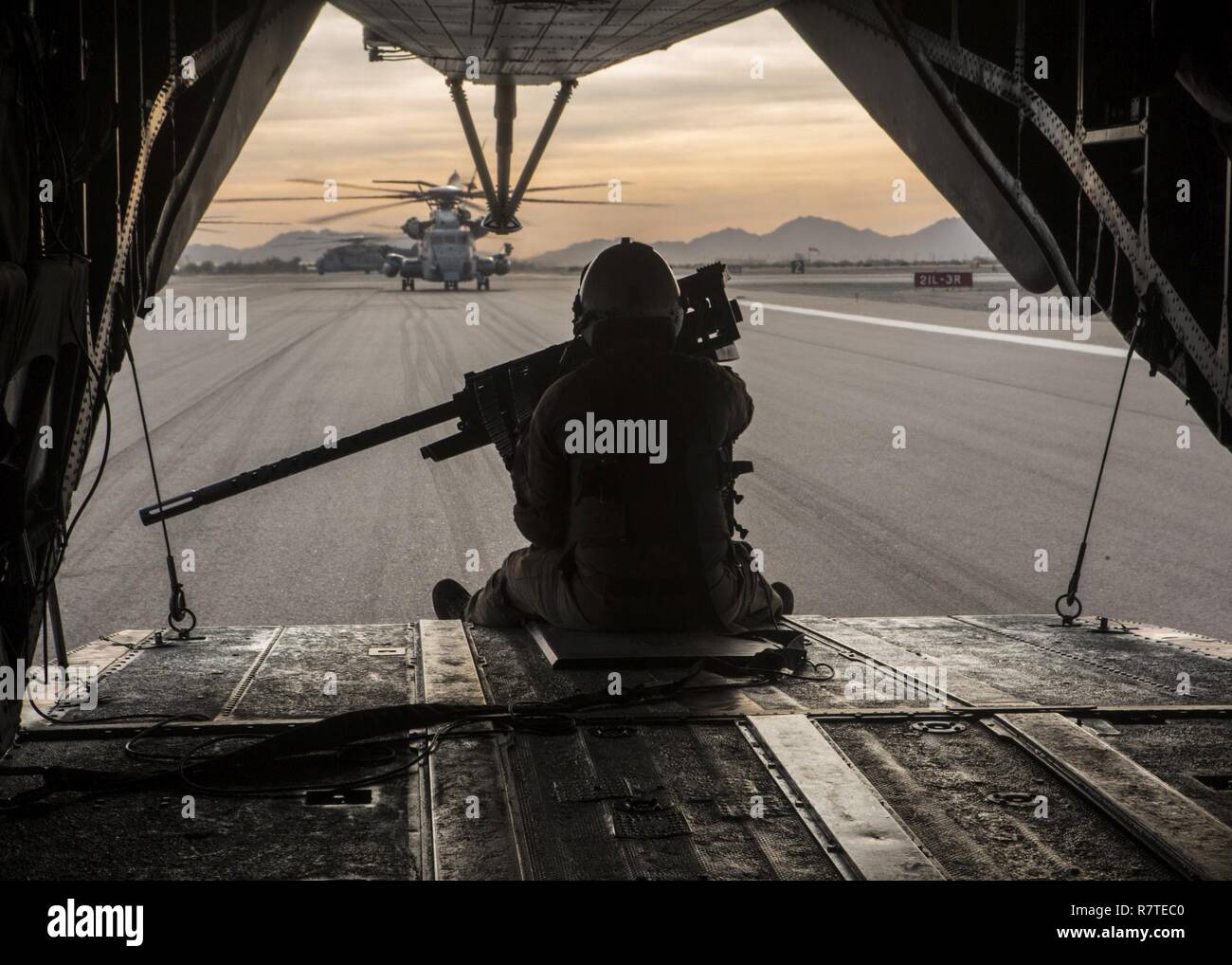 A U.S. Marine prepares for take-off on a CH-53E Super Stallion during a CH-53 day battle drill in support of Weapons and Tactics Instructors course (WTI) 2-17 at Marine Corps Air Station Yuma, Ariz., April 8, 2017. WTI is a seven-week training event hosted by Marine Aviation Weapons and Tactics Squadron One (MAWTS-1) cadre, which emphasizes operational integration of the six functions of Marine Corps aviation in support of a Marine Air Ground Task Force and provides standardized advanced tactical training and certification of unit instructor qualifications to support Marine Aviation Training a Stock Photo