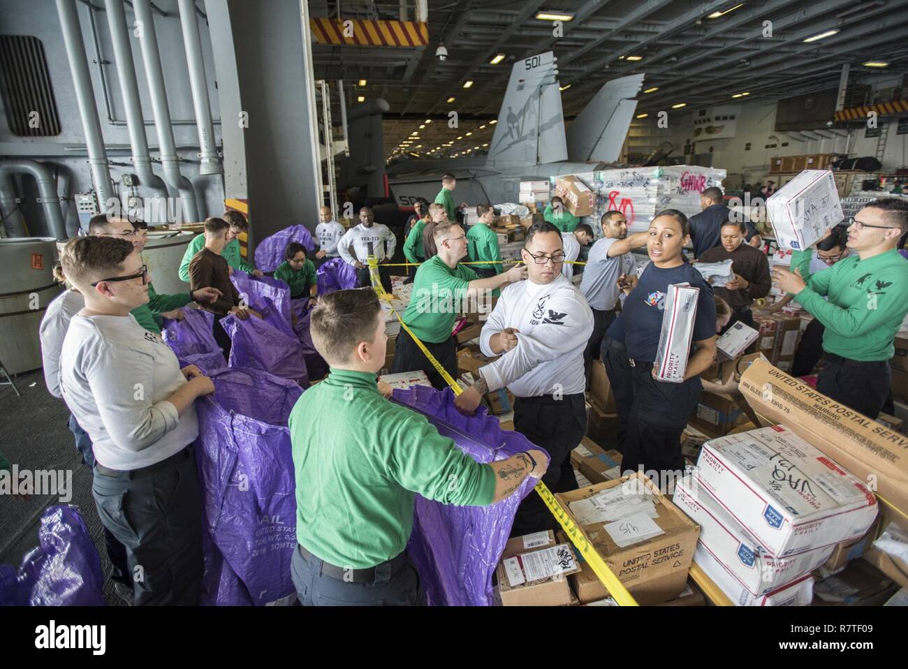 ARABIAN GULF (April 5, 2017) Sailors distribute mail in the hangar bay aboard the aircraft carrier USS George H.W. Bush (CVN 77) (GHWB). GHWB is deployed in the U.S. 5th Fleet area of operations in support of maritime security operations designed to reassure allies and partners, and preserve the freedom of navigation and the free flow of commerce in the region. Stock Photo