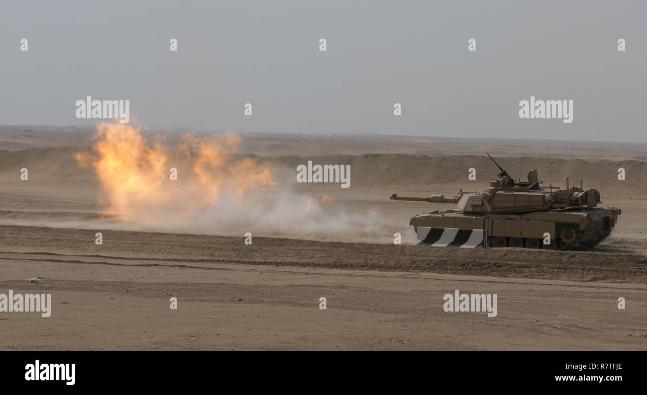 A 3rd Armored Brigade Combat Team, 1st Cavalry Division M1A2 Abrams Main Battle Tank engages targets during the brigade's Table VI qualifications at the Udairi Range Complex March 29. The brigade tank and Bradley crews spent about two weeks in the field conducting sustainment gunnery to ensure all the crews qualified at day and night fire to maintain proficiency. Stock Photo