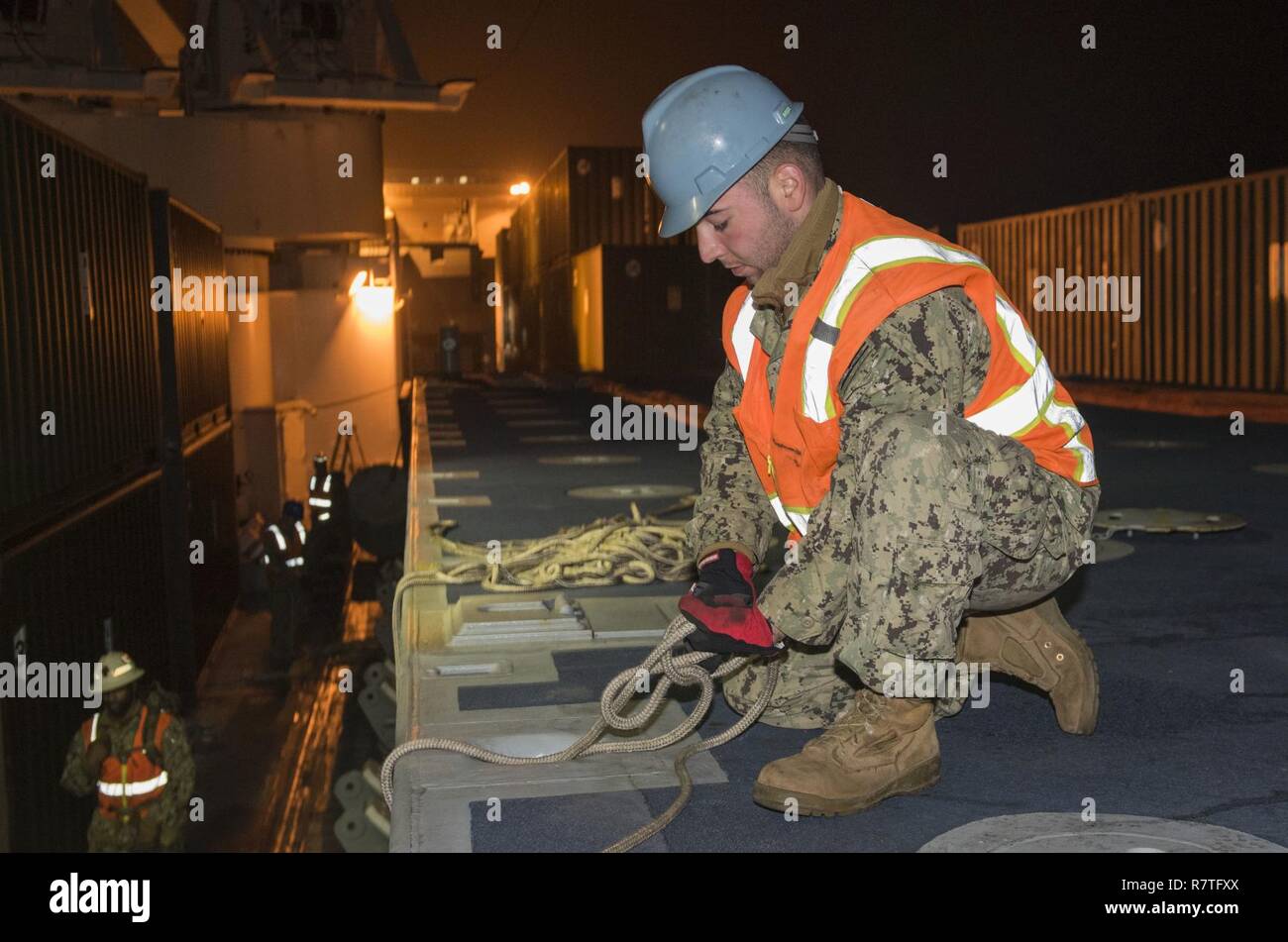 POHANG, Republic of Korea (Apr. 9, 2017) Boatswain Mate Seaman Nicholas Kakoules from Navy Cargo Handling Battalion One secures lines to a beach module for unloading from Navy Maritime Prepositioning Force Ship USNS Pililaau (T-AK 304) using Improved Navy Lighterage System (INLS) while anchored off the coast of Pohang, Republic of Korea during Combined Joint Logistics Over the Shore (CJLOTS) April 9. CJLOTS is a biennial exercise conducted by military and civilian personnel from the United States and the Republic of Korea, training to deliver and redeploy military cargo as a part of the large  Stock Photo