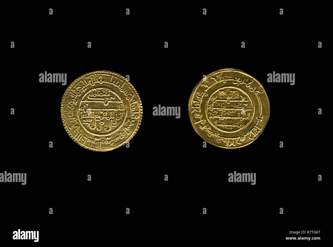 Córdoba, Spain - Dec 7th, 2018: Almoravid Period gold dinar, 970 AC. Obverse and reverse. Córdoba Archaeological Museum, Spain Stock Photo