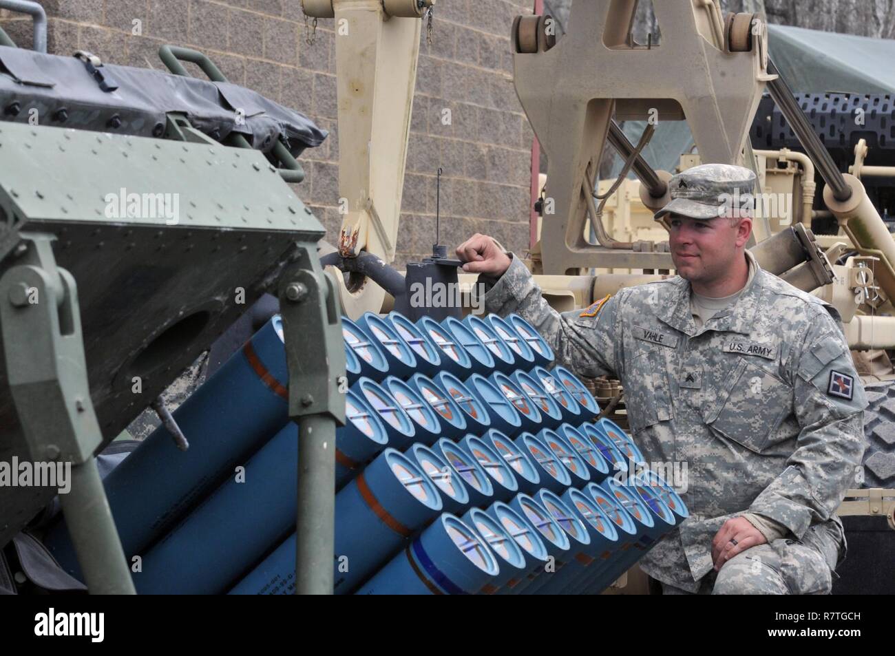 U.S. Army Reserve Cpl. Nicholas Vahle with the 979th Mobility Augmentation Company, 478th Engineer Battalion, 926th Engineer Brigade, 412th Theater Engineer Command, based in Lexington, Ky., pauses to look at 40 training mine canisters in one panel of a M136 Volcano weapons system during the company's training at Wilcox Range on Fort Knox, Ky.,April 1, 2017. This was part of Engineer Qualification Table XII. This company was the first U.S. Army Reserve unit to accomplish this feat. Stock Photo