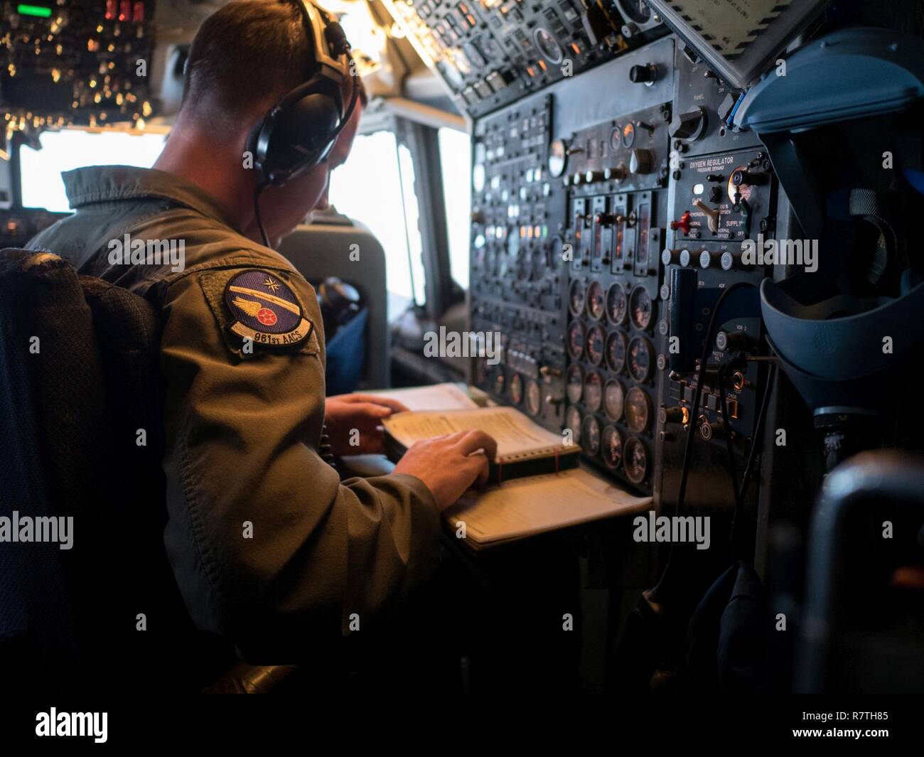 A U S Air Force Flight Engineer From The 961st Airborne Air Control Squadron Monitors E 3 Sentry Aircraft Systems March 28 17 While Flying In An Over The Pacific Ocean The Flight Engineer A U S Air Force Flight Engineer From The 961st Airborne Air Control Squadron Monitors E 3 Sentry Aircraft Systems March 28 17 While Flying In An Over The Pacific Ocean The Flight Engineer