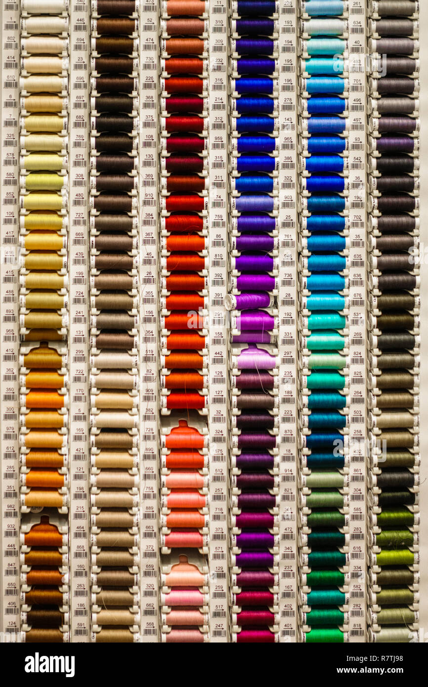 Sewing threads on shelf for sale Stock Photo - Alamy image.
