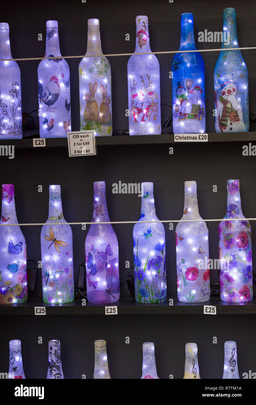 Decorative light bottle gifts on market stall at Winchester Christmas