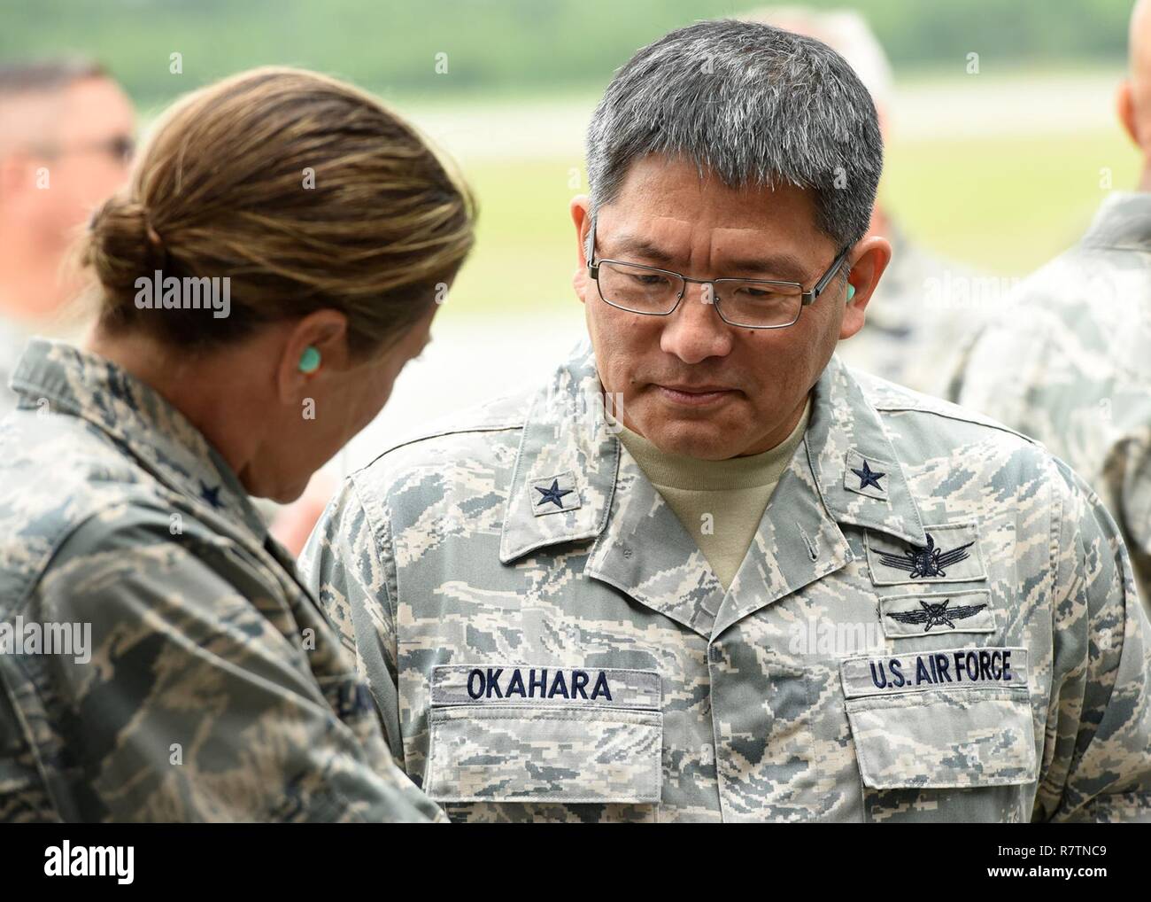 Brig. Gen. Ryan T. Okahara, Chief of Staff and Commander, Hawaii Air National Guard, and Brig. Gen. Jill A. Lannan, ANG Assistant to the Commander, 24th Air Force, spend a few moments together on the flight line here at Eielson AFB, Alaska, July 11, 2017. The generals were part of a group of Air Force Space Command leaders who are visiting some of the locations and facilities of the 168th Wing, Alaska ANG, where they are meeting with Airmen and leaders to talk about the future of space missions for Alaska’s Citizen Airmen. Stock Photo