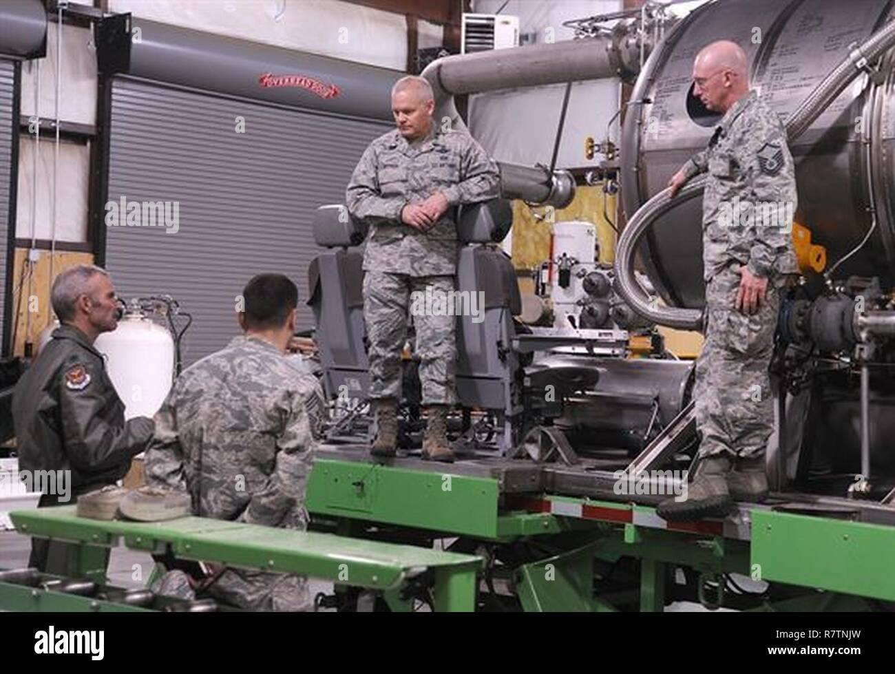 Lt. Col. Luke Thompson, bottom left, the 302nd Airlift Wing chief of aerial firefighting, and Master Sgt. Tom Freeman, top right, a Modular Airborne Fire Fighting System-qualified C-130 loadmaster assigned to the 731st Airlift Squadron, discuss the function and capabilities of the U.S. Forest Service MAFFS unit with Maj. Gen. John Stokes, the 22nd Air Force commander, and Chief Master Sgt. Clinton Ronan, the 22nd AF command chief, at Peterson Air Force Base, Colo., Apr. 1, 2017. Stokes and Ronan met with Citizen Airmen from several 302nd AW squadrons during their visit during the April Unit Tr Stock Photo