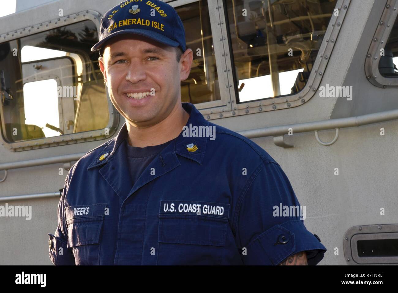 Coast Guard Petty Officer 1st Class Tyler Weeks, a machinery technician at Station Emerald Isle, North Carolina, poses for a portrait in front of a 45-foot Response Boat-Medium at the station, March 31, 2017. Weeks is the head of the engineering department at the station and supervises four other machinery technicians. Stock Photo