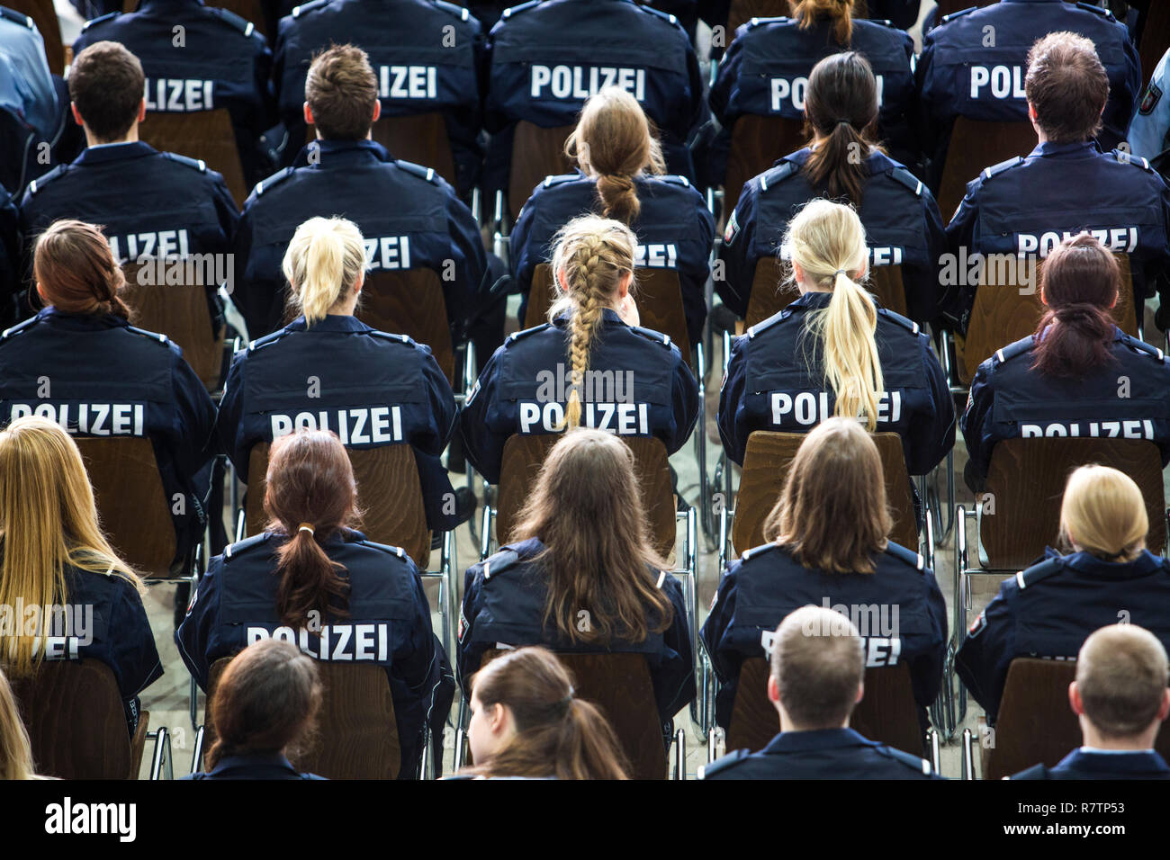 Police commissioner candidates, trainees of the Polizei NRW or North Rhine-Westphalia Police, sitting at a meeting in an Stock Photo