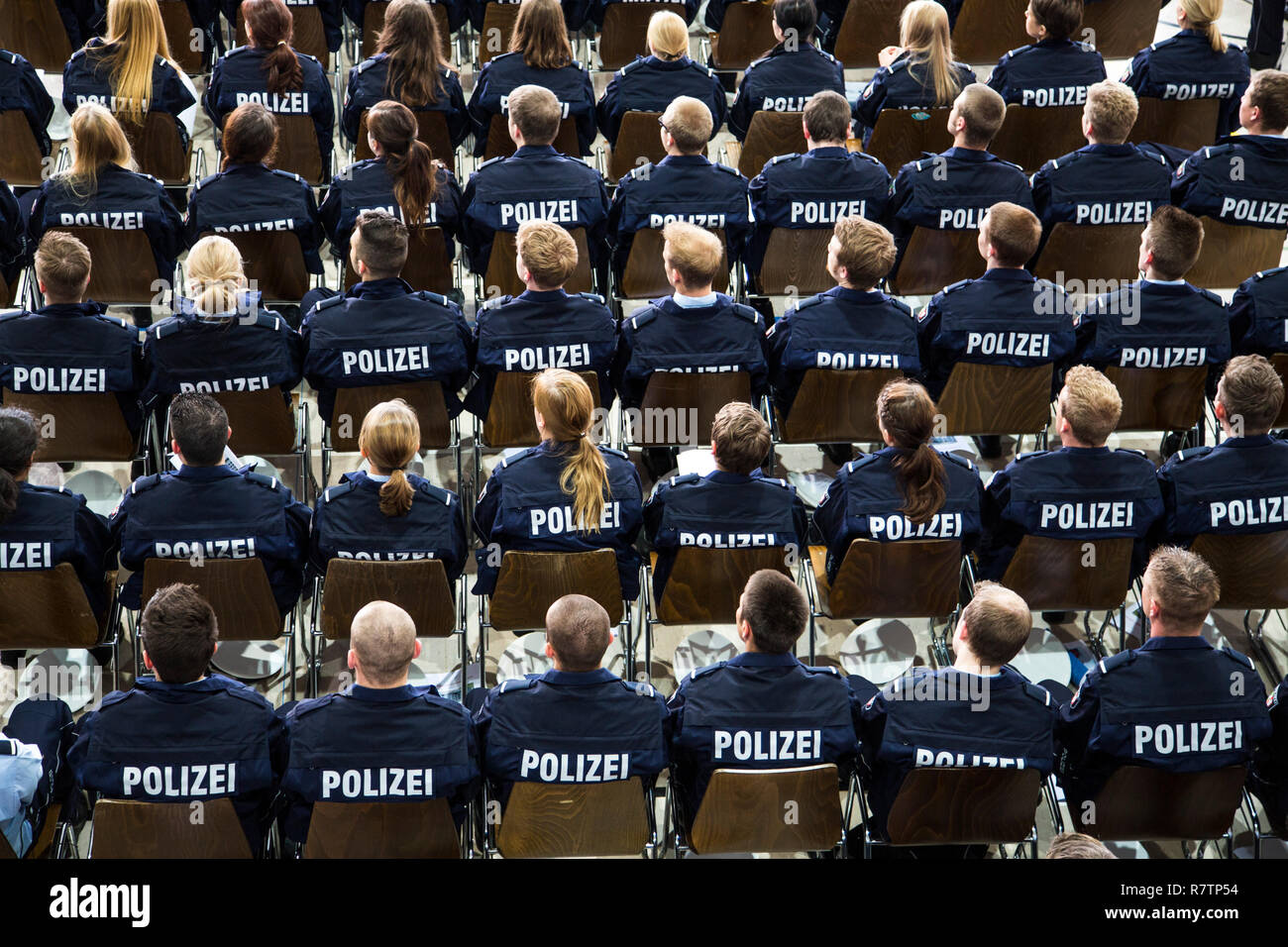Police commissioner candidates, trainees of the Polizei NRW or North Rhine-Westphalia Police, sitting at a meeting in an Stock Photo