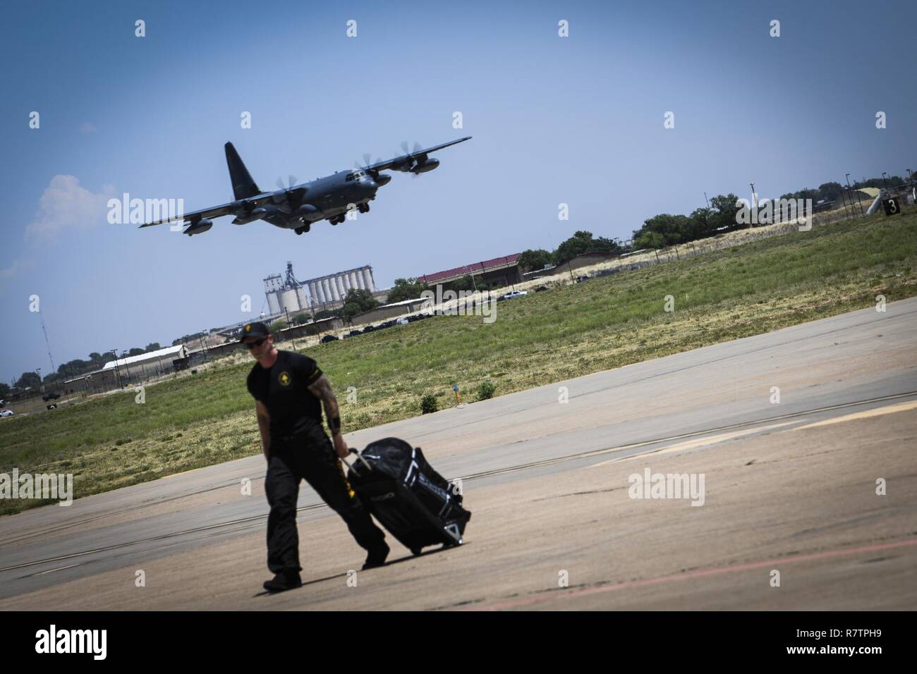 A Special Operations Command servicemember walks on the flightline at