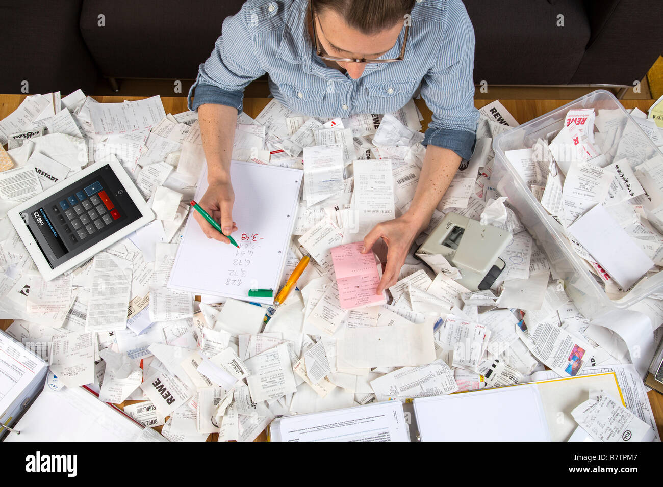 Woman with documents, records, invoices and receipts for the tax return Stock Photo
