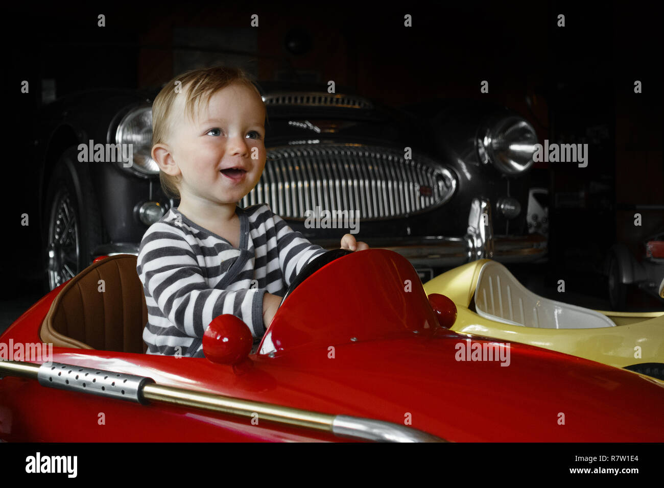Baby boy driving toy car Stock Photo Alamy